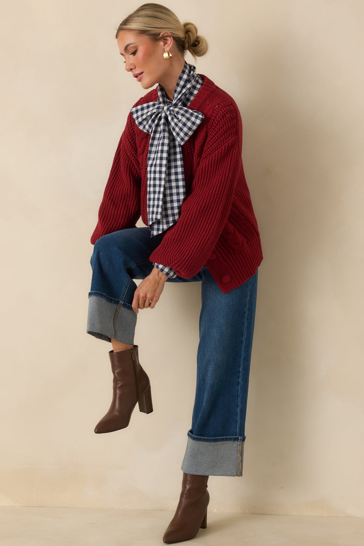 Rich burgundy cardigan with tonal knit-covered buttons and prominent cable-knit texture across the front.