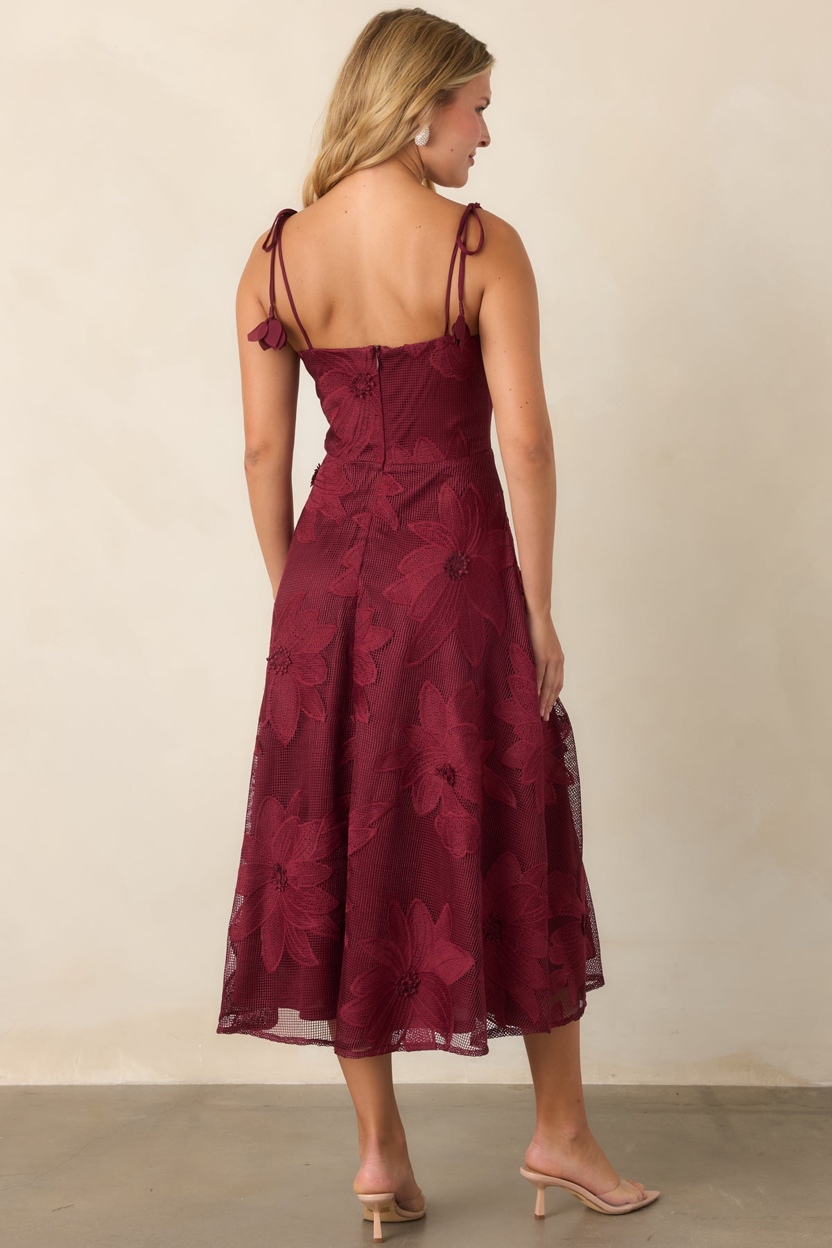 Rear of the burgundy lace dress showcasing the tie straps and concealed back zipper.
