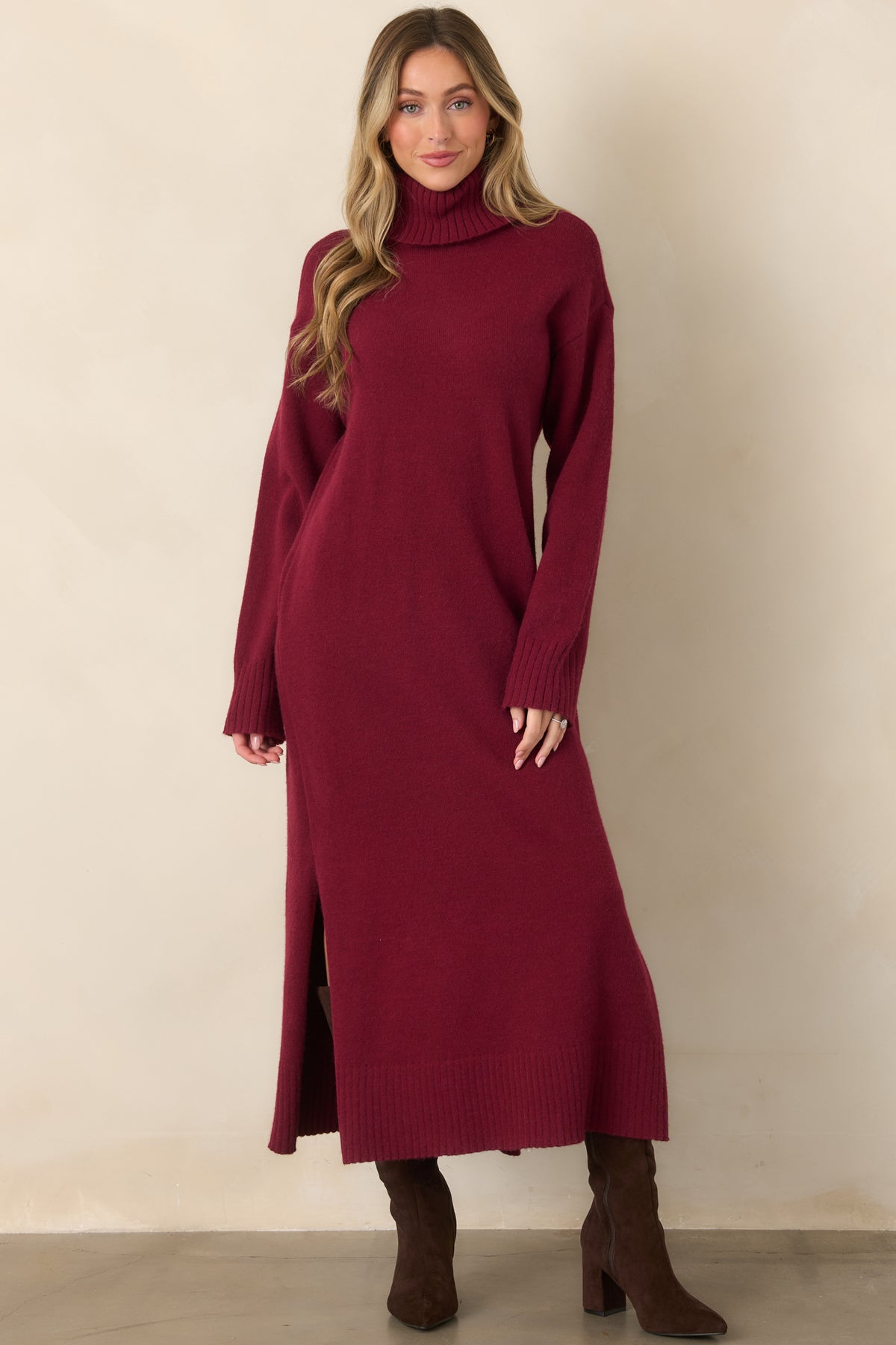 Soft stretch sweater dress showcasing a comfortable midi silhouette, long sleeves, ribbed trim, and a rich burgundy color.

