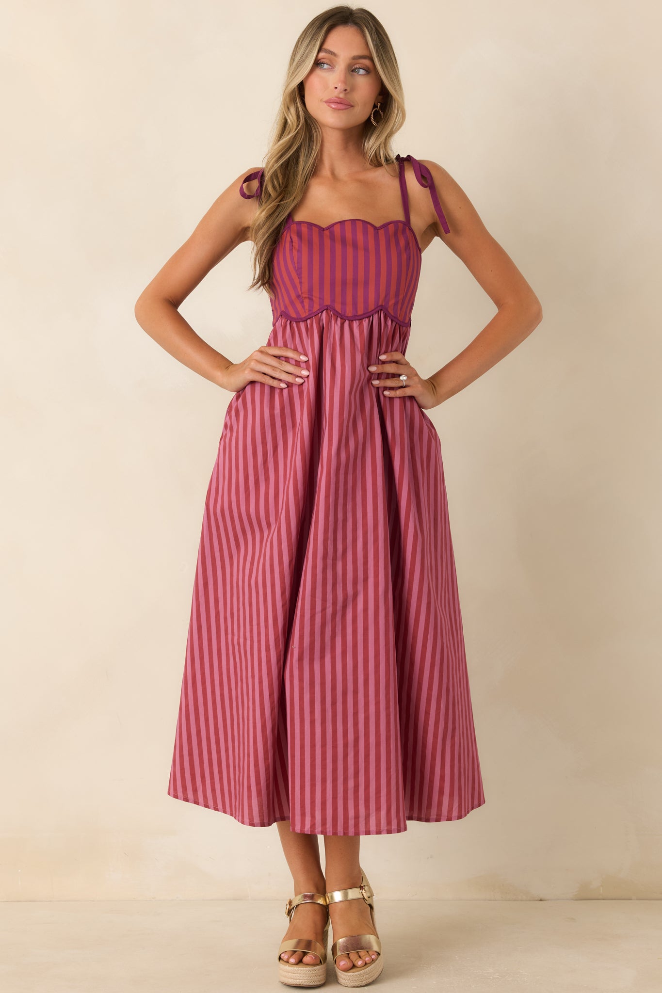 Playful midi dress showcasing mixed burgundy and mauve stripes with a full gathered skirt.