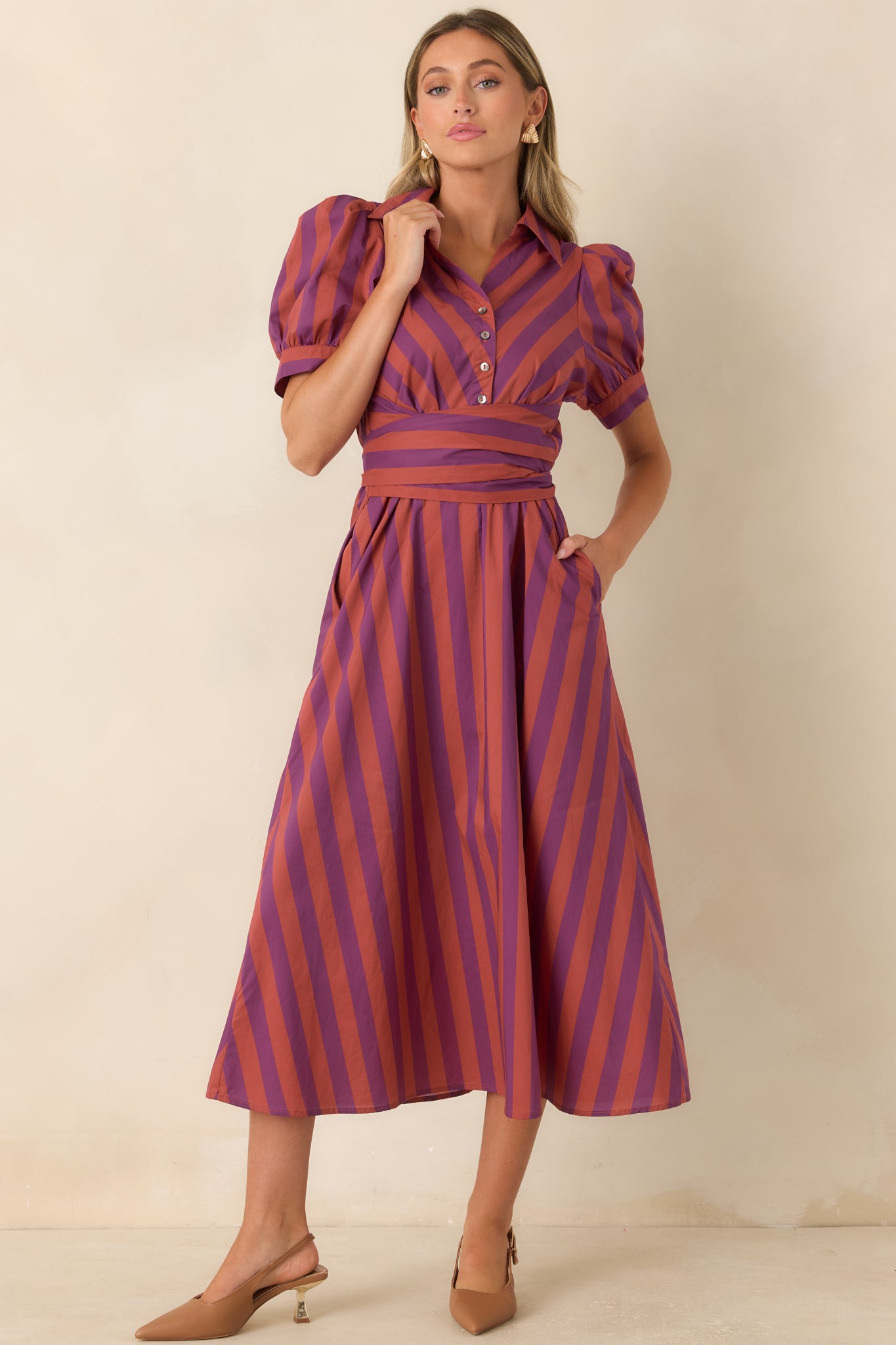 Burgundy and plum midi dress featuring a tailored button-front design, structured collar, and wrap-style waist sash. 
