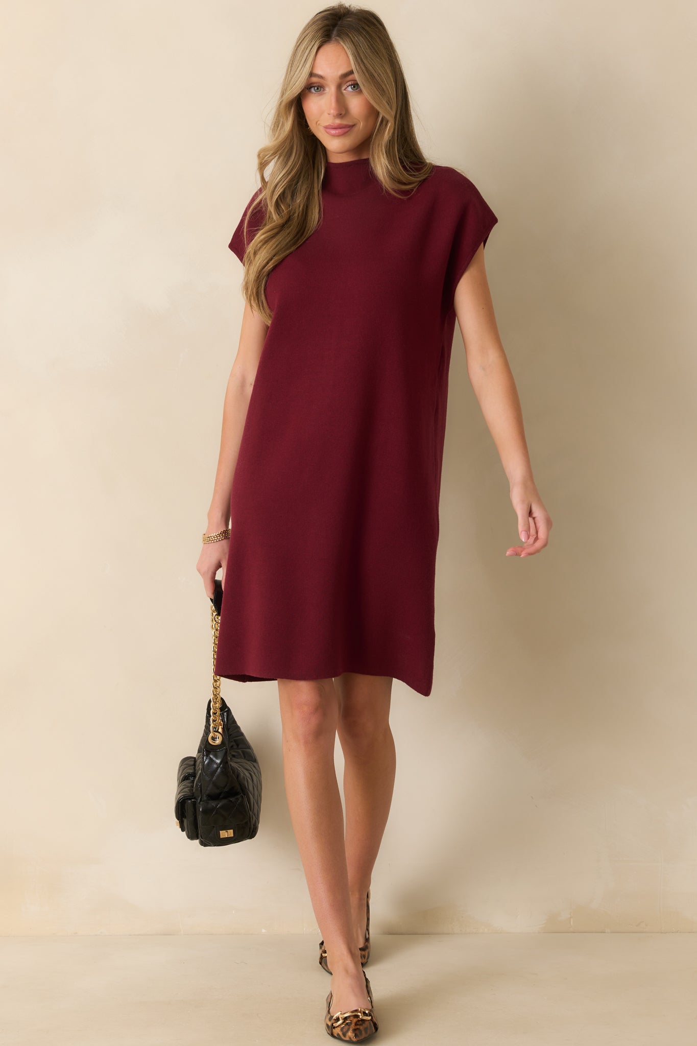 Burgundy ribbed knit dress with short sleeves and a mock neck, displayed from the front, hemline ending mid-thigh.