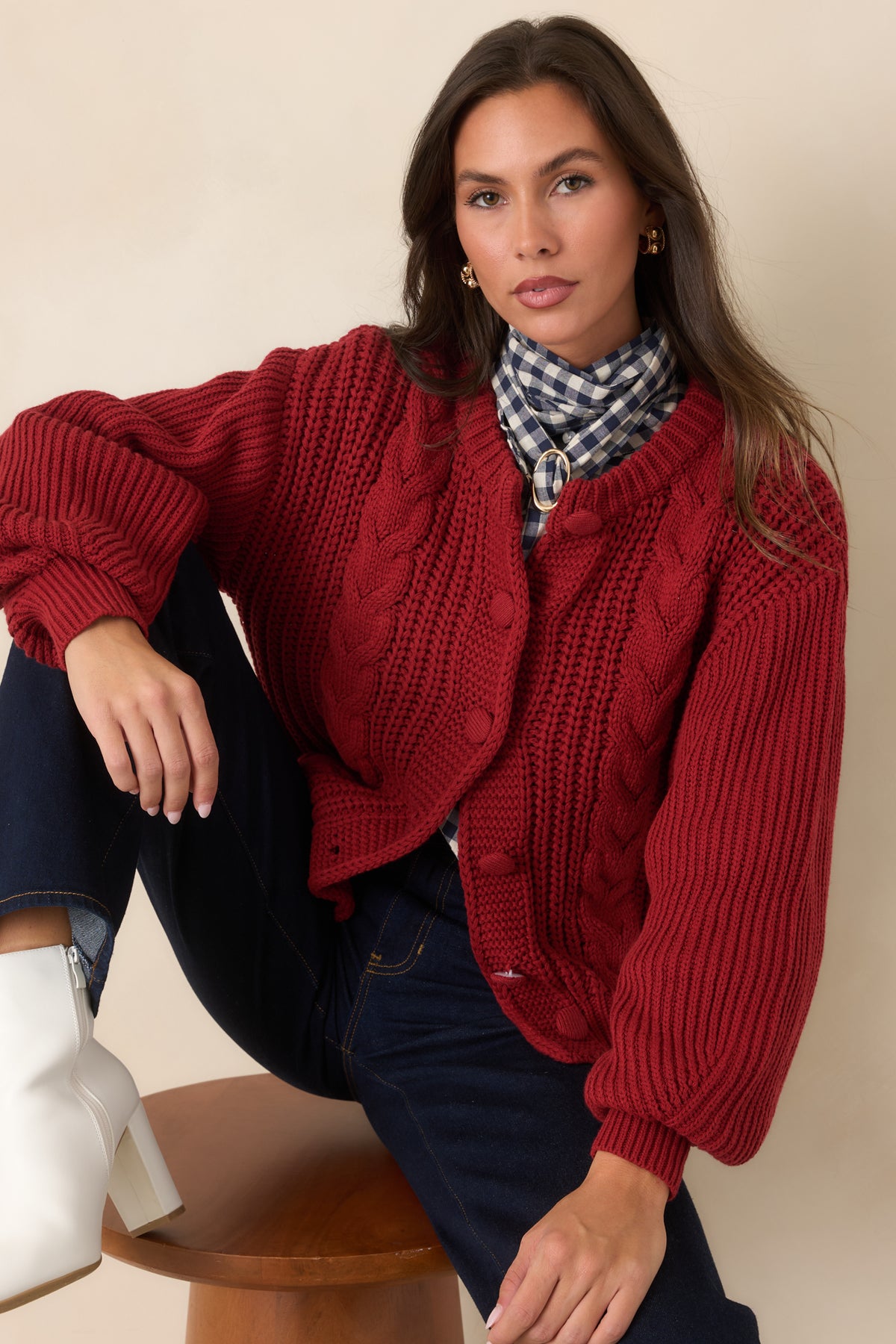 Ribbed texture extends through the burgundy cardigan sleeve for added definition.