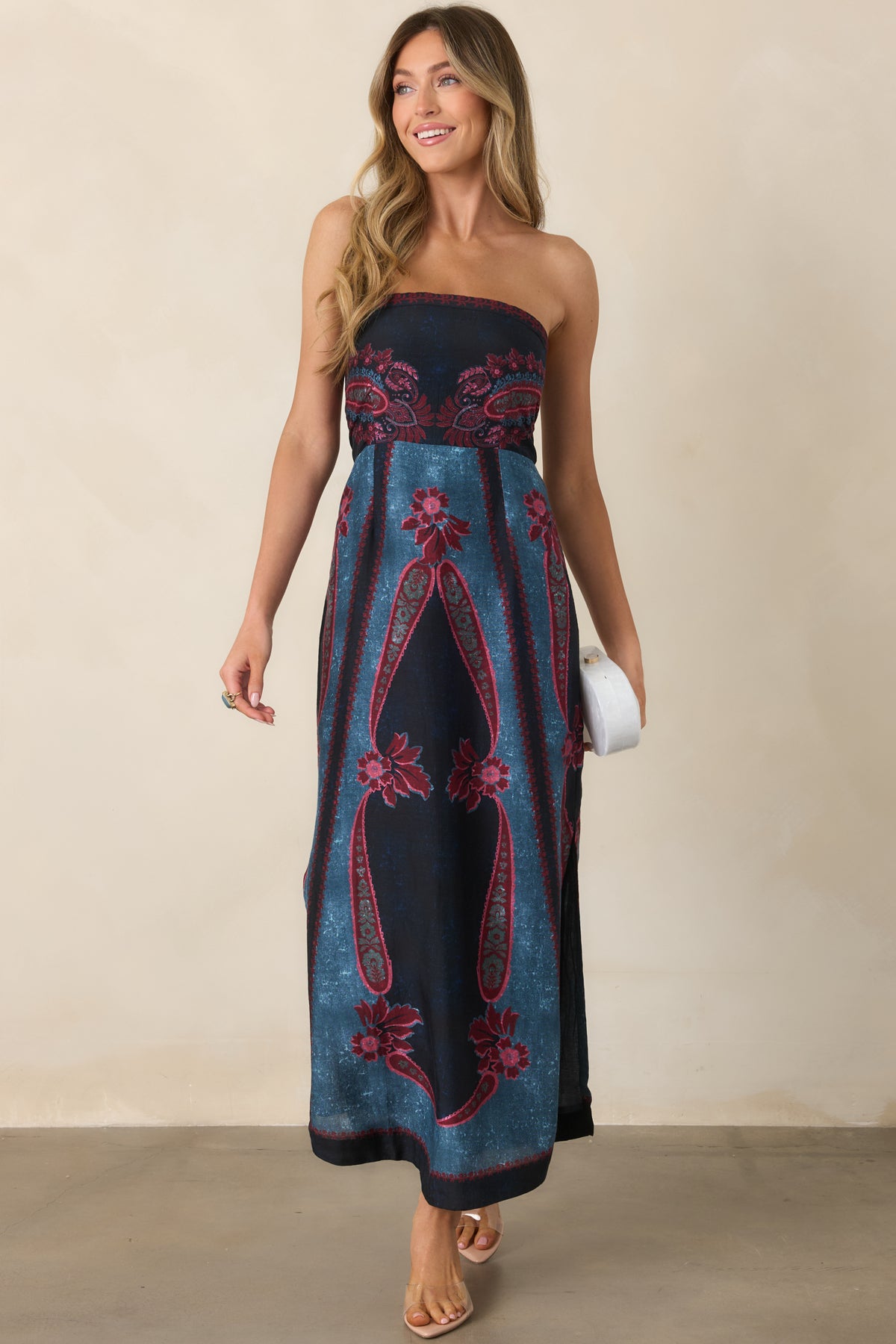 Strapless dress with burgundy and rose paisley florals surrounding deep navy and teal blue panels, finished with a gently flared skirt.