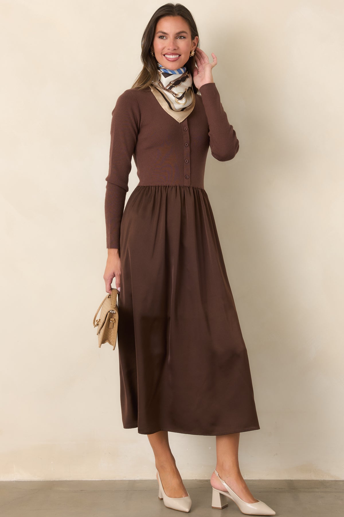 Burgundy dress showcasing the round neckline, tonal button front, and gently flared satin skirt.