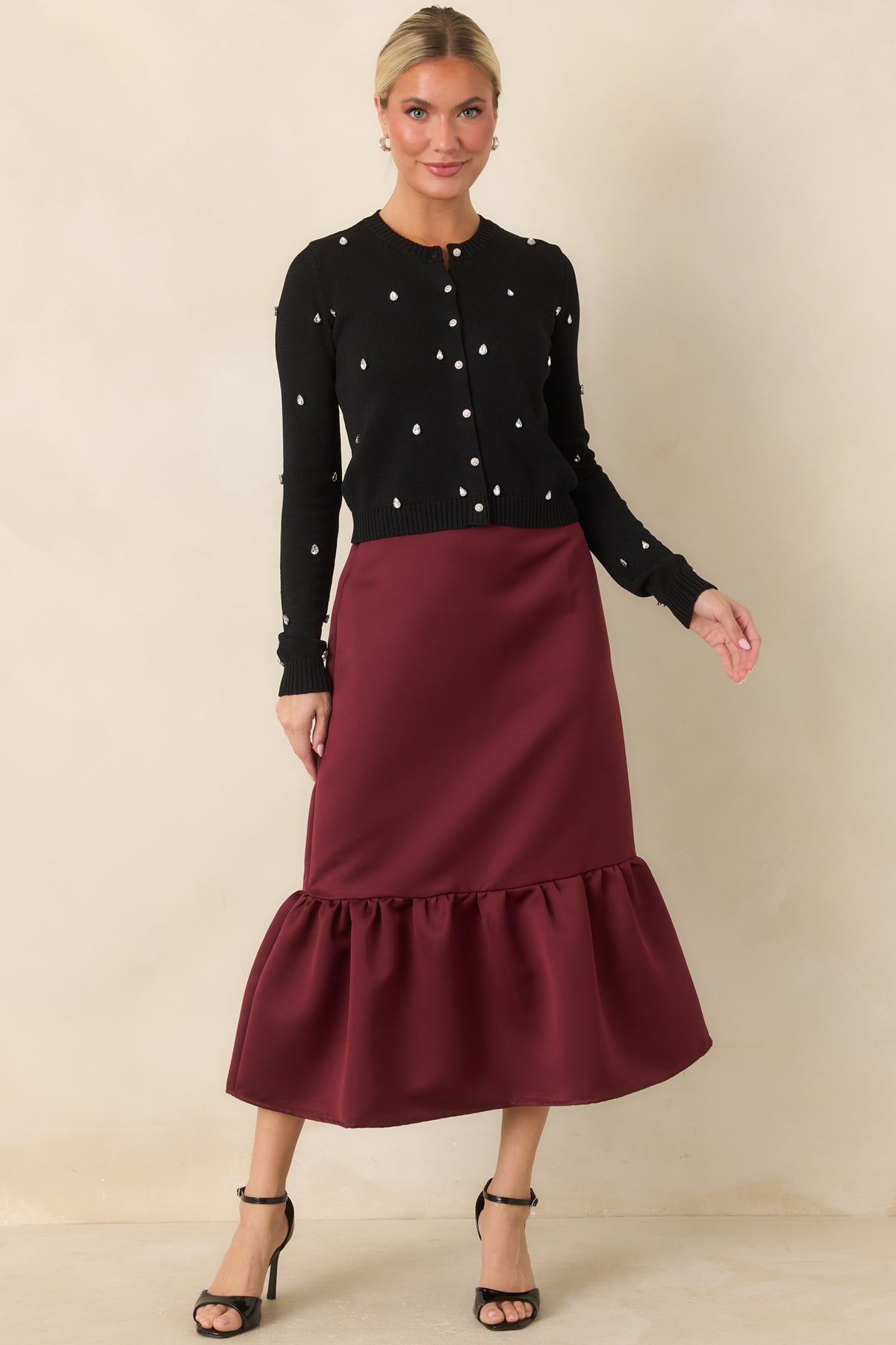 Burgundy satin midi skirt with a smooth finish and fitted silhouette.