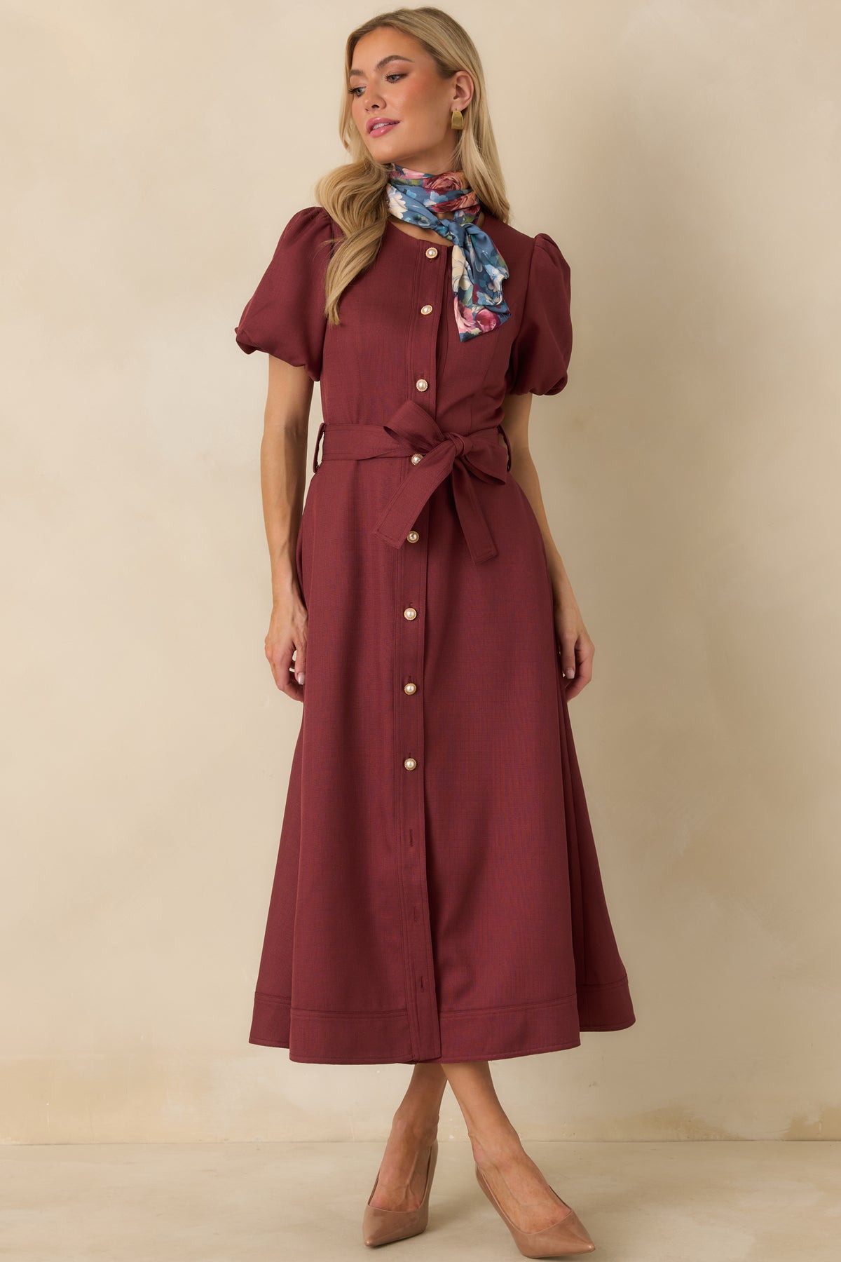 Textured burgundy midi dress featuring a functional pearl button front, self-tie waist belt, and full A-line skirt.