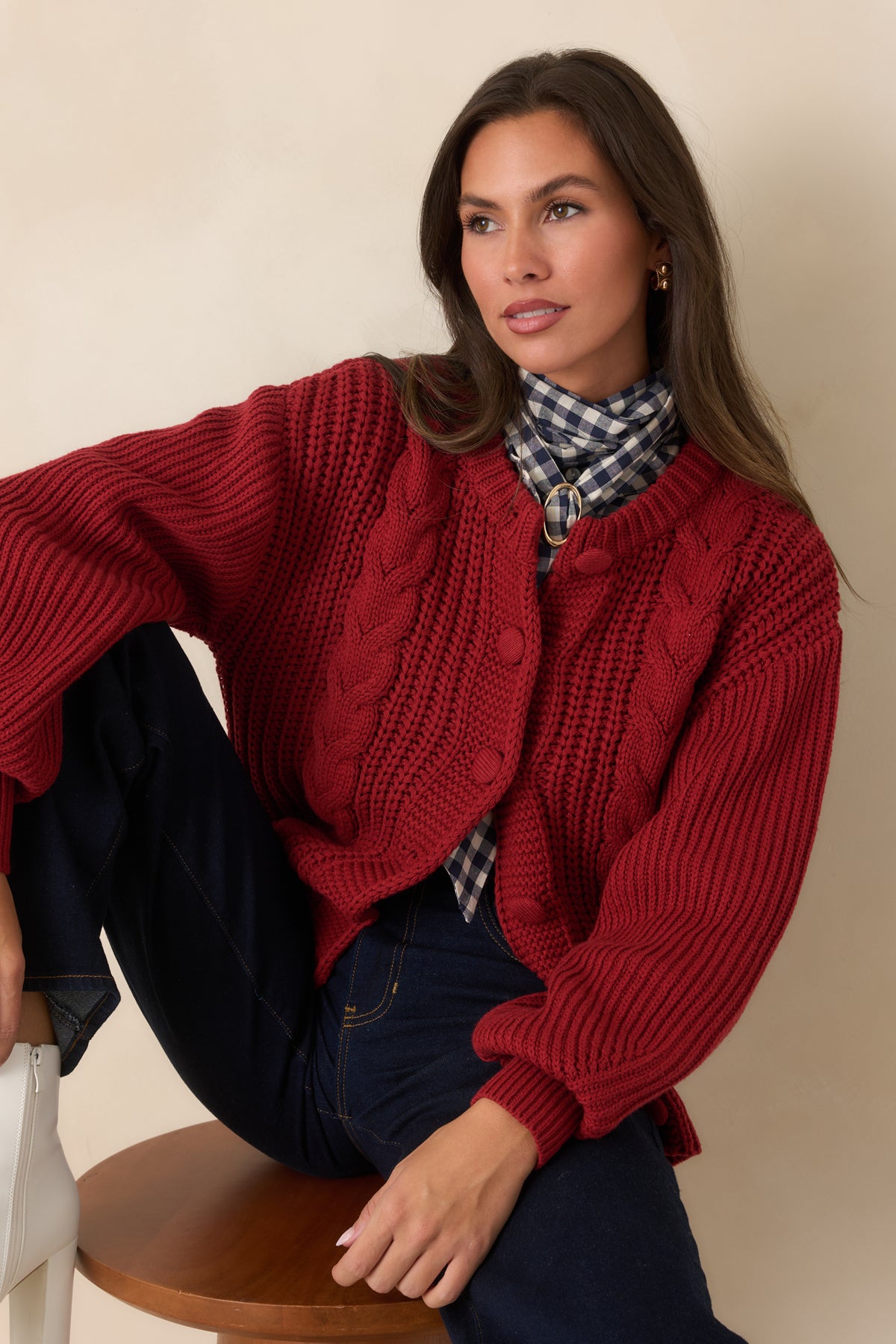 Tonal knit-covered button detailing provides a subtle finish to the burgundy cardigan.