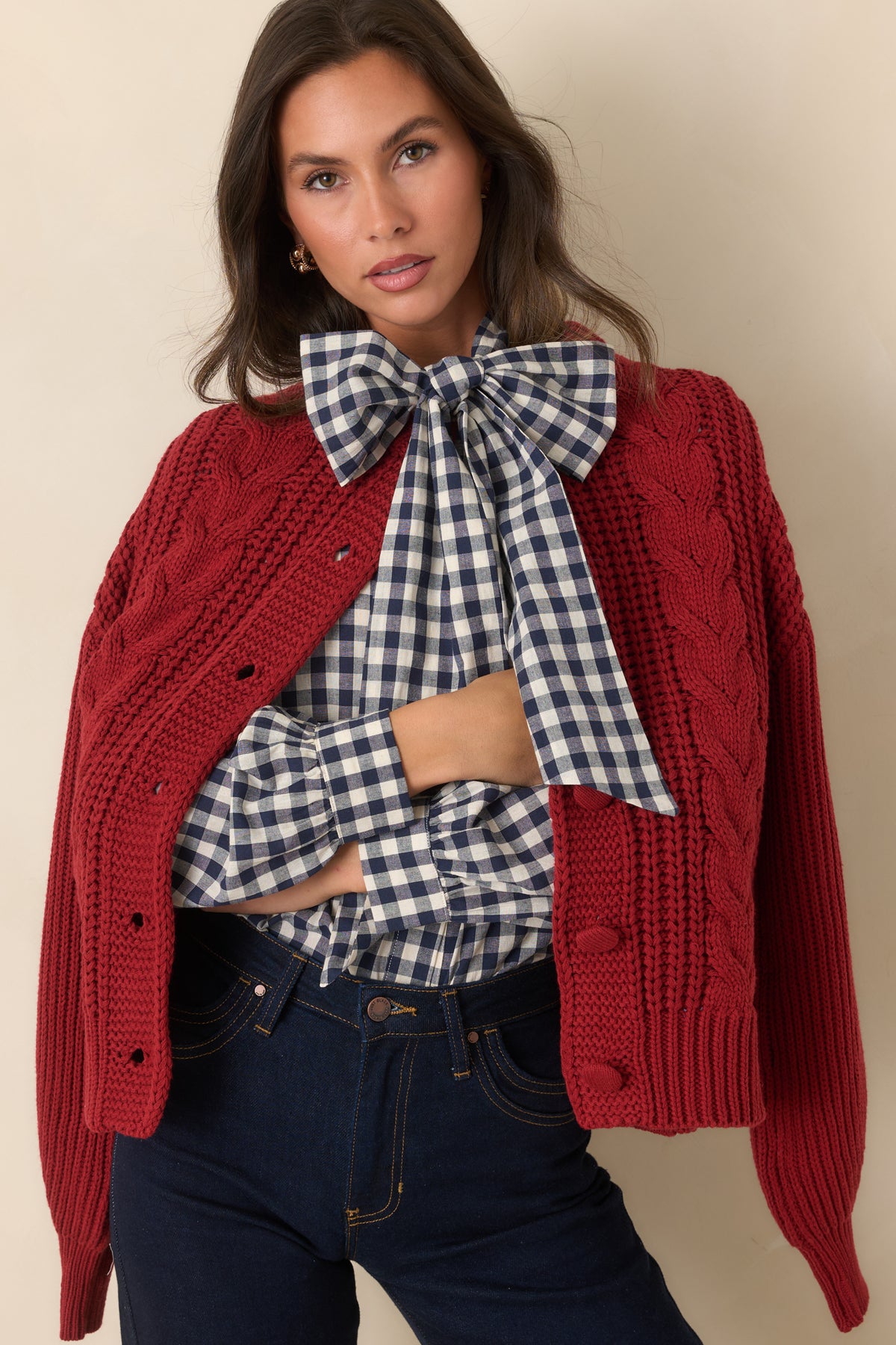 Tonal knit-covered buttons stand out against the rich burgundy knit of the cardigan.