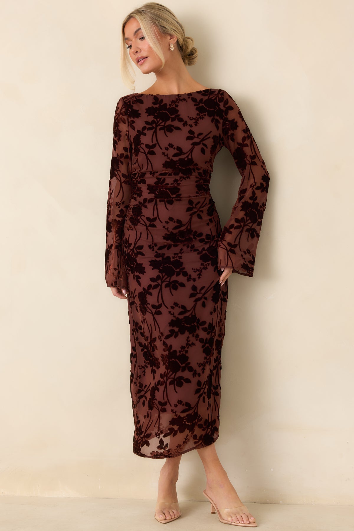 Deep burgundy velvet burnout dress featuring a wide boat neckline, ruched waist, and slim midi skirt.