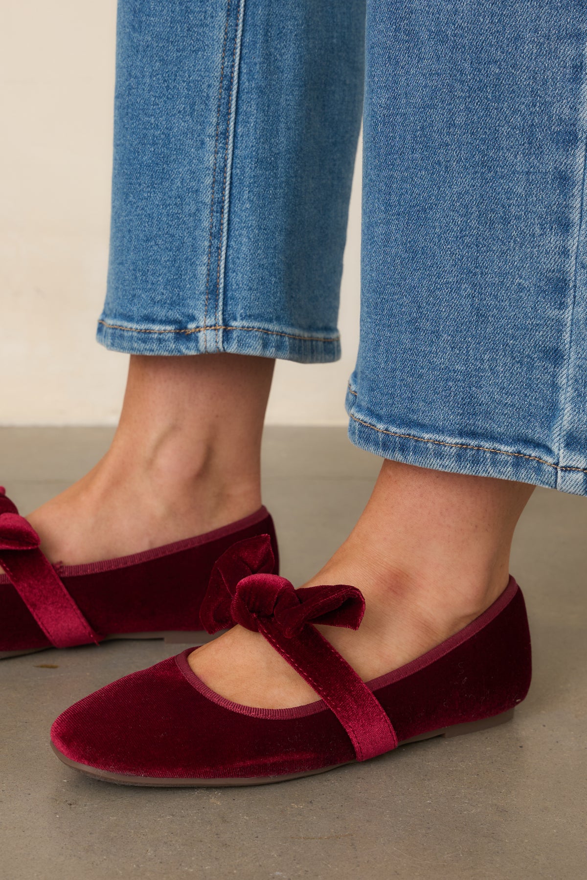 Rounded toes and tonal trim complement the romantic velvet finish of these low-heel flats.