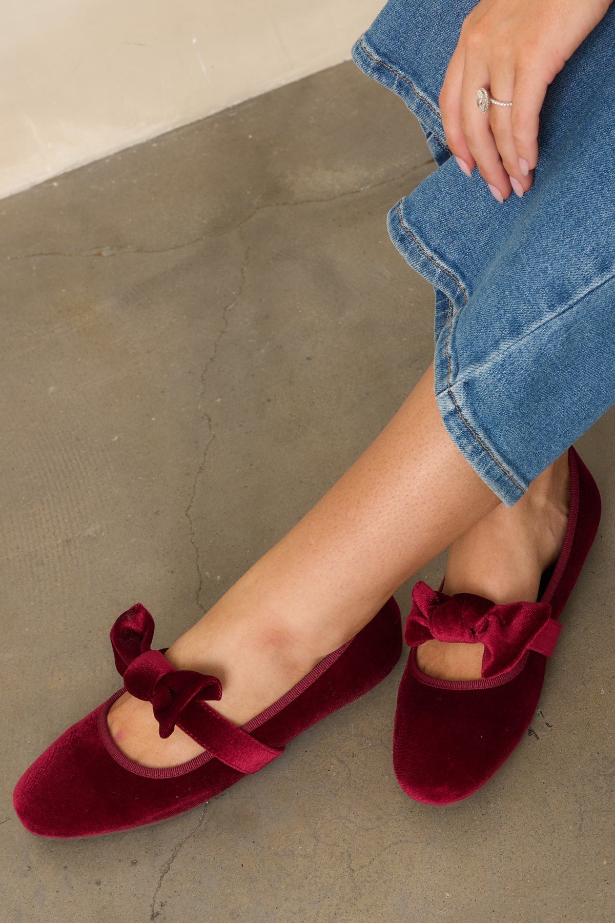 The statement bow and rich burgundy velvet highlight the feminine detailing across the Mary Jane strap.