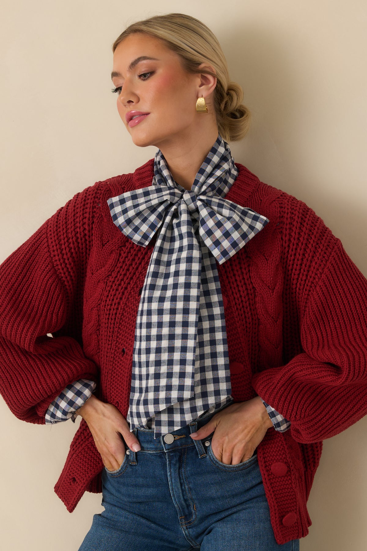 Burgundy cardigan showing the generous volume of its long sleeve and fitted ribbed cuff.