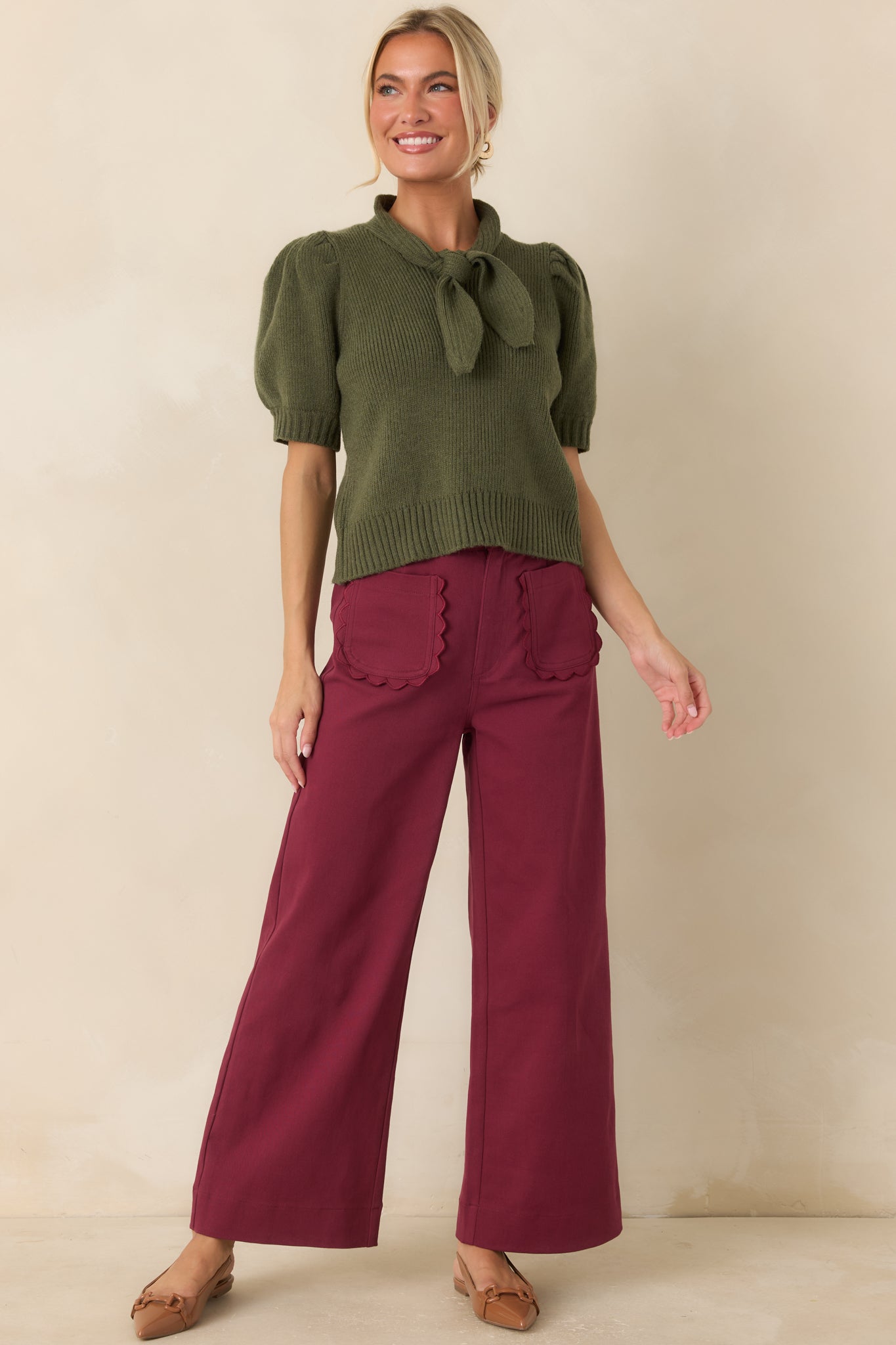 Rich burgundy wide-leg pants with a front button and zipper closure, belt loops, and a refined everyday design.