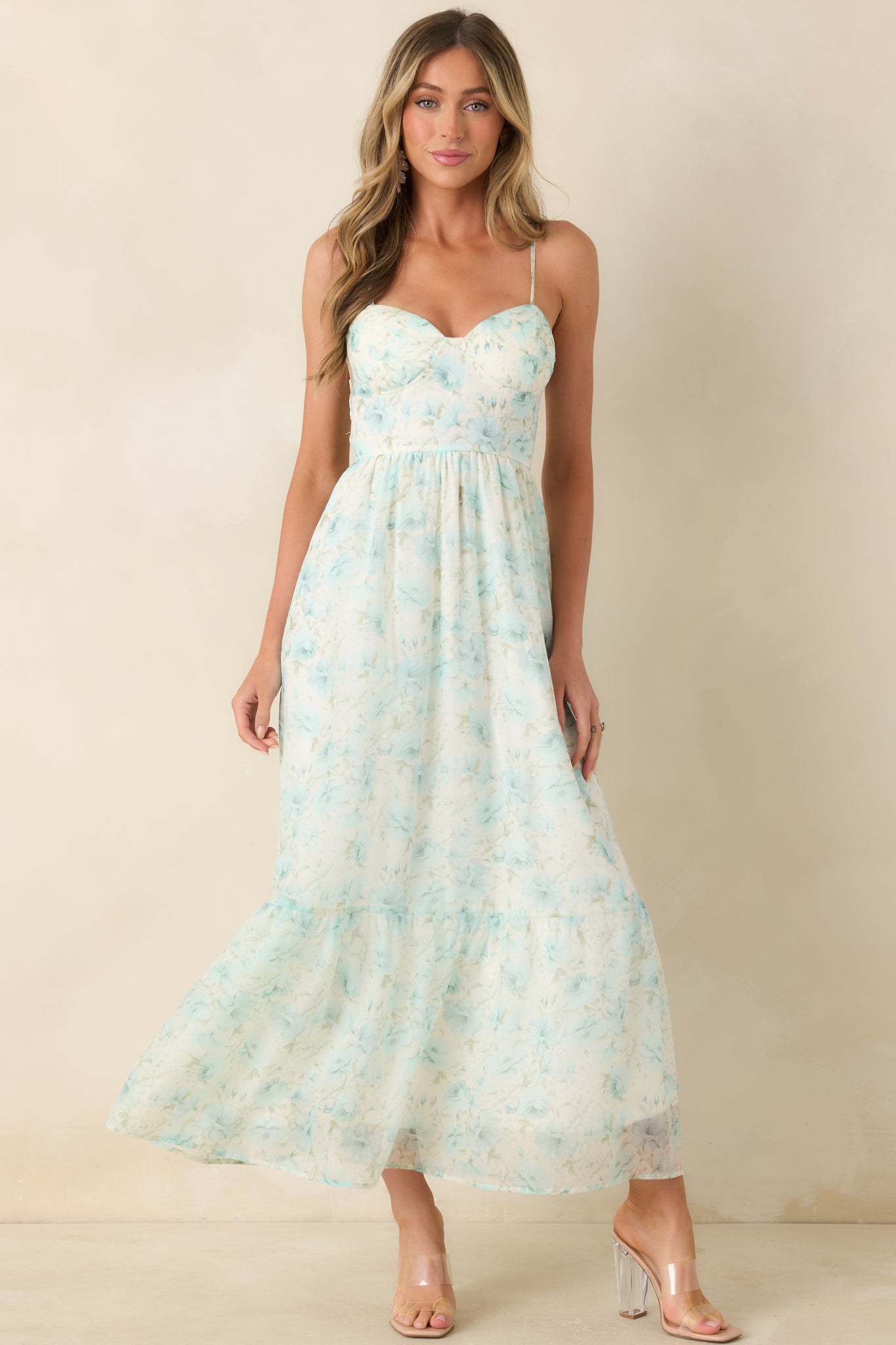 Bustier bodice midi dress featuring aqua floral print and softly draped skirt.