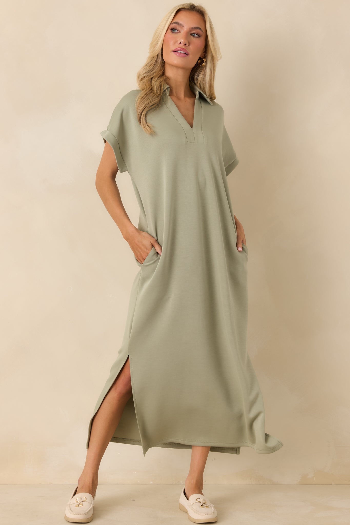 Buttery soft sage green midi dress with a collared v-neck design, relaxed shape, and side hem slits for movement.