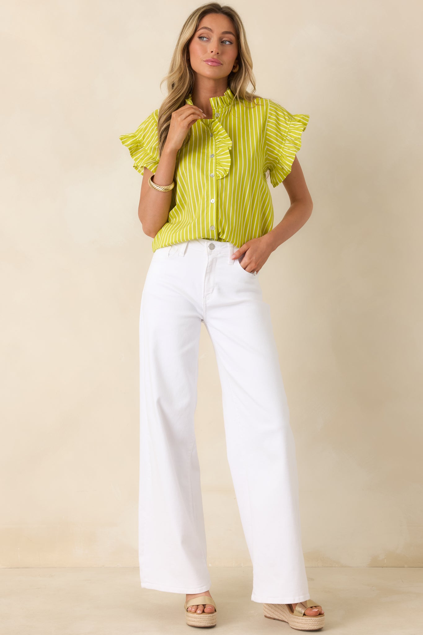 Button-front blouse with subtle ruffle detailing and easy, flowing silhouette.