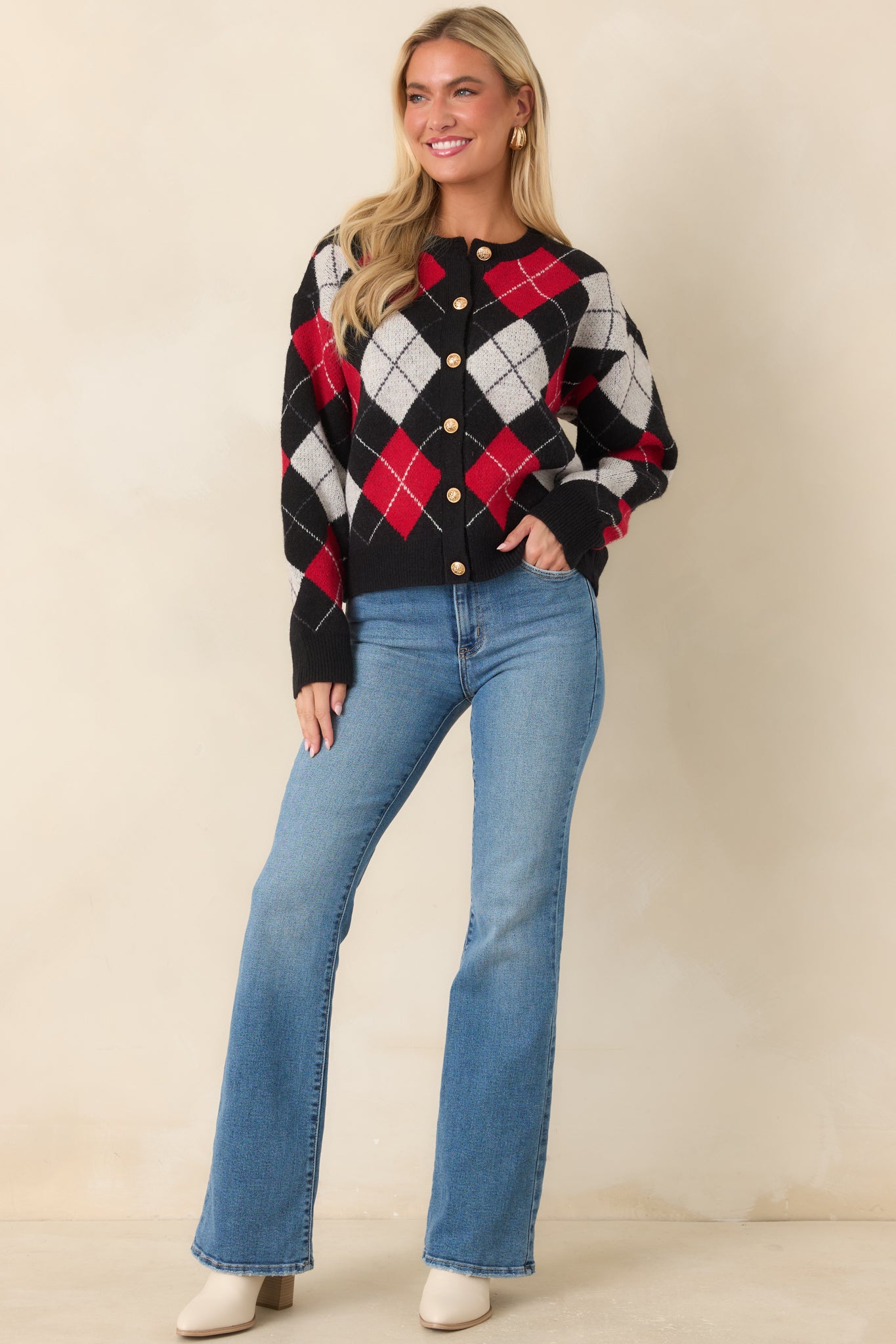 Button-front cardigan with a round neckline, dropped shoulders, and ribbed trim detailing.