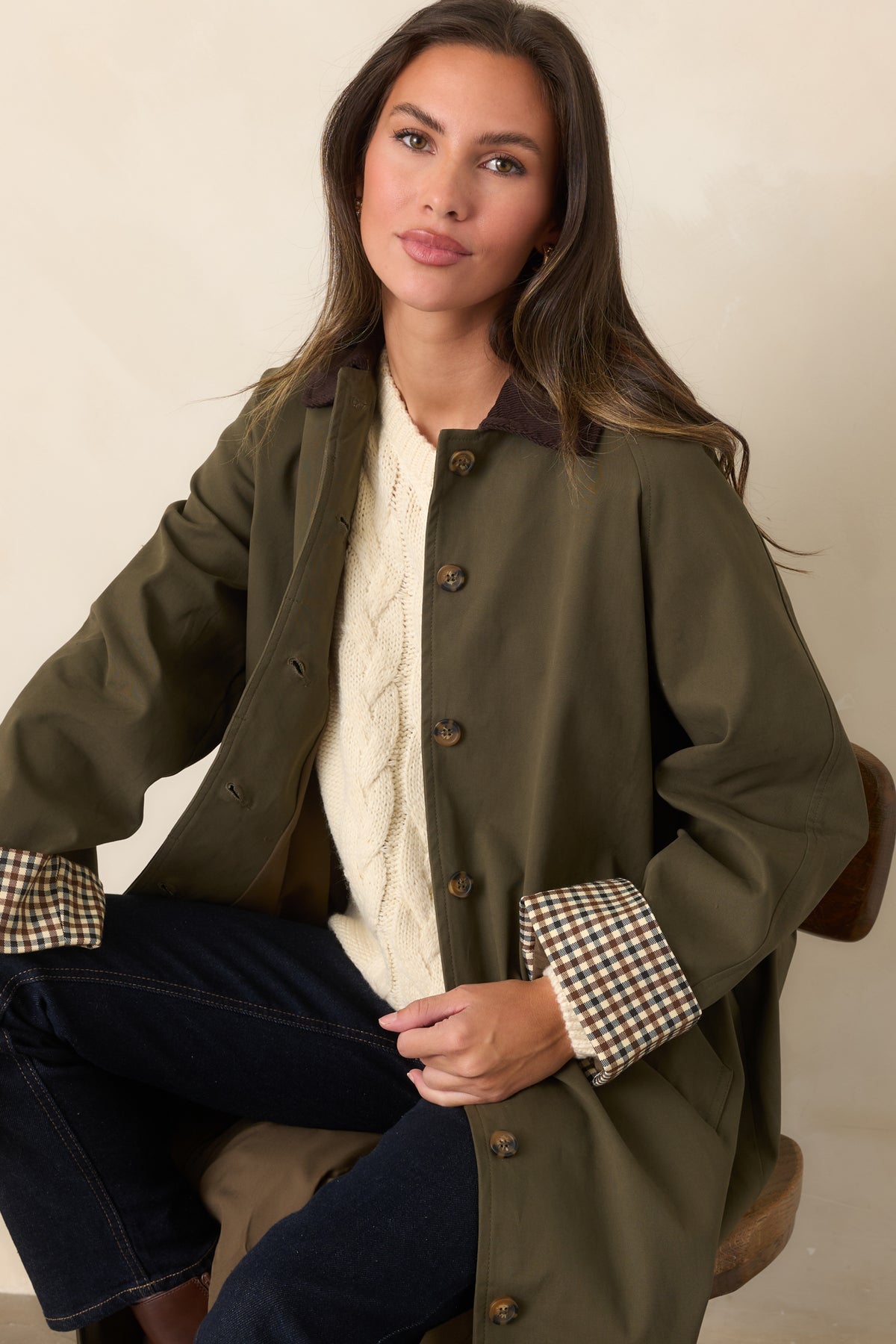 Button-front coat with a coordinating tie belt and functional side pockets.