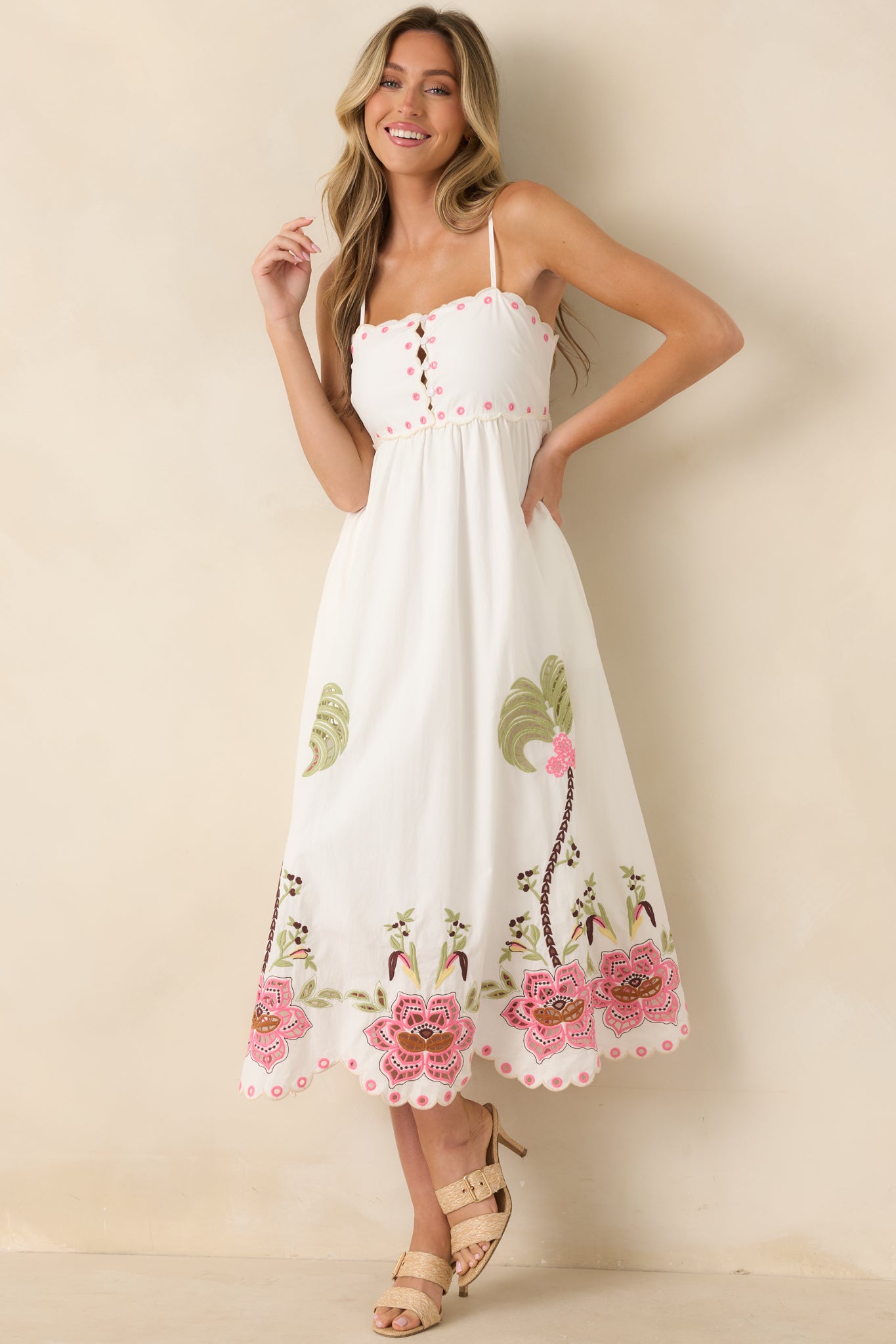 Lightweight midi dress designed with a peek-a-boo button-front bodice, delicate embroidery, side pockets, and a breezy A-line skirt.