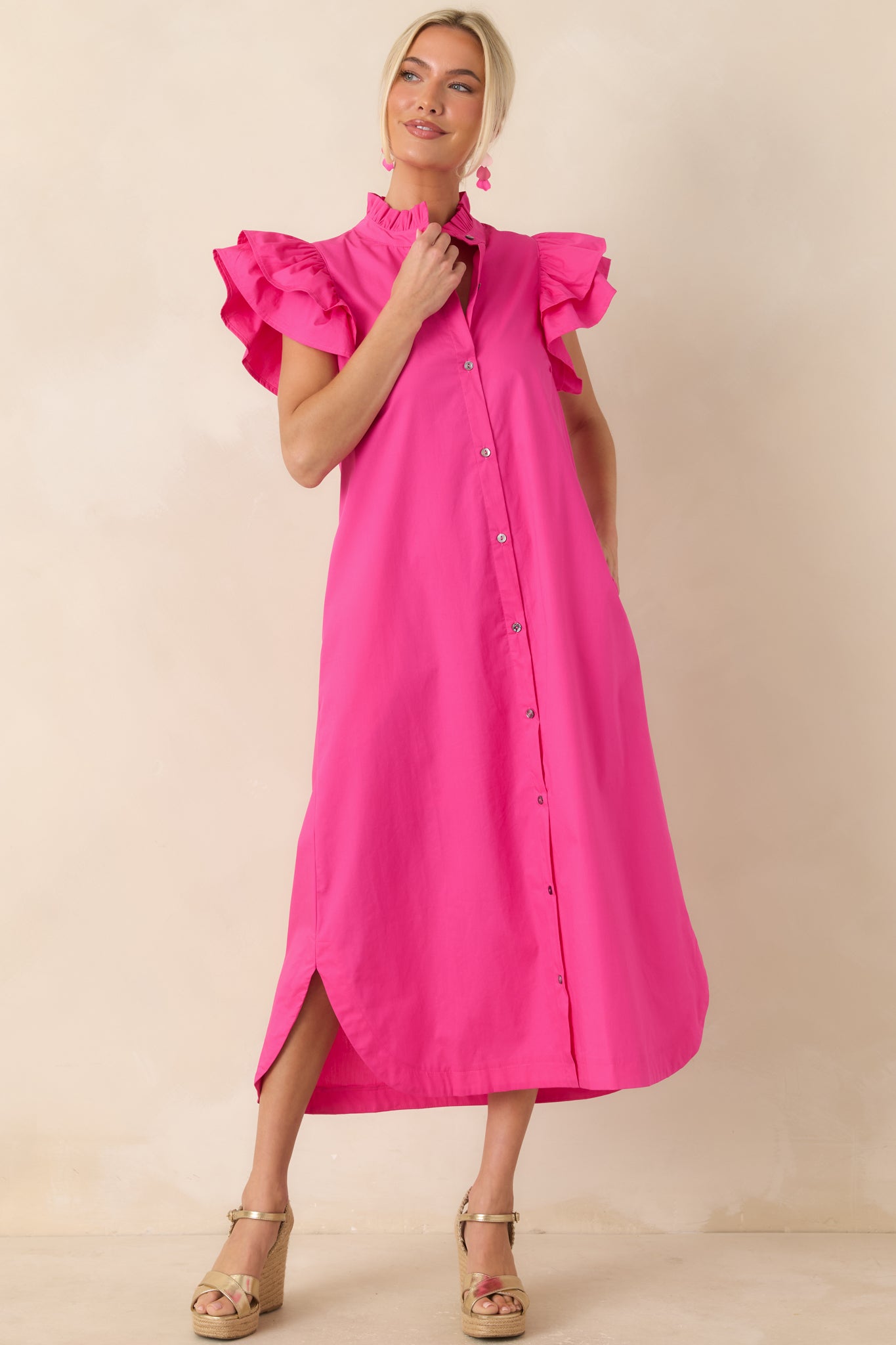 Button-front midi dress with statement flutter sleeves, breathable cotton fabric, and a polished yet easy-to-wear fit.