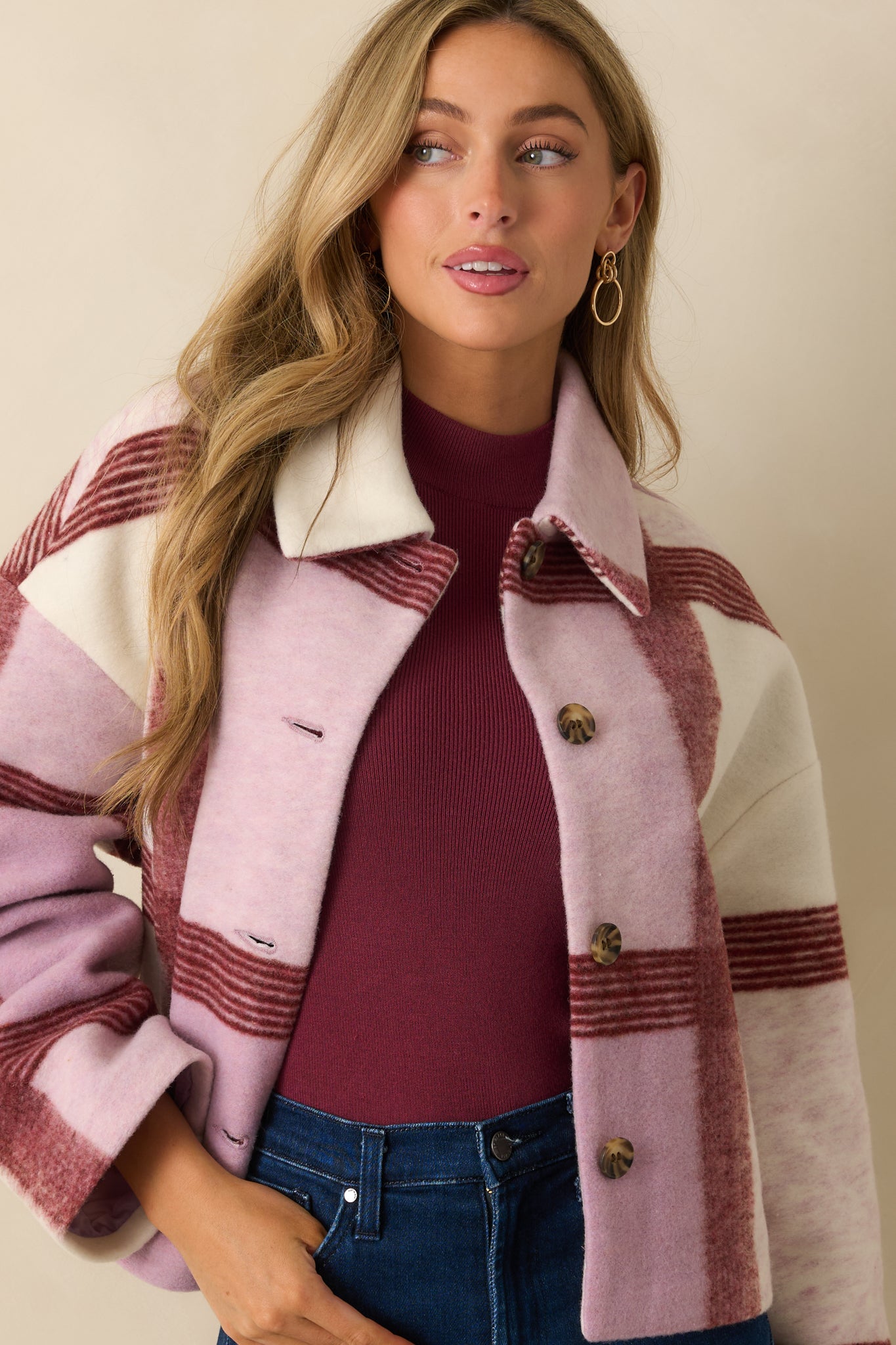Focus on the button placket and lower front hem of the lilac plaid jacket, showcasing its refined detailing and cozy finish.