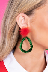 Model shown wearing earrings that feature a pompom stud, tinsel-like detailing, and a secure post backing.