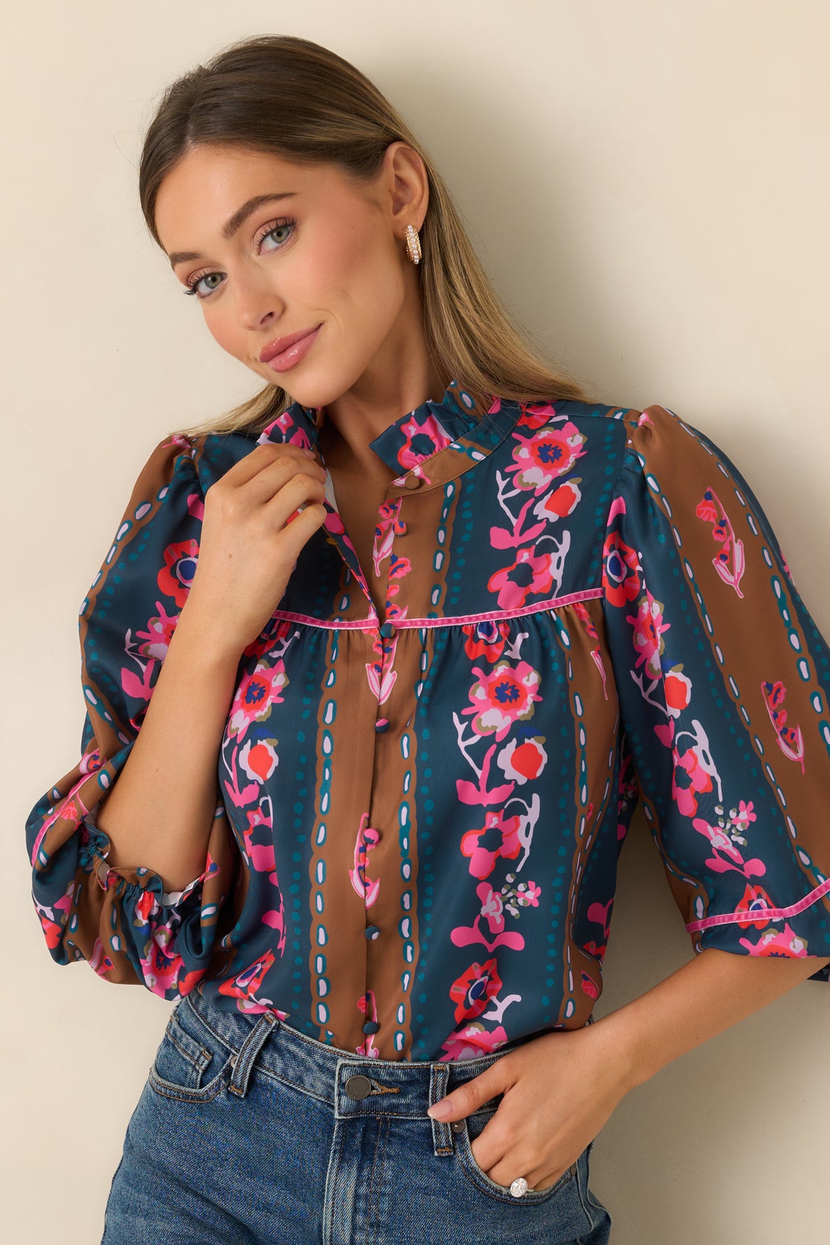 Gentle gathers create a relaxed shape beneath the pink-trimmed yoke of the tapestry stripe blouse.
