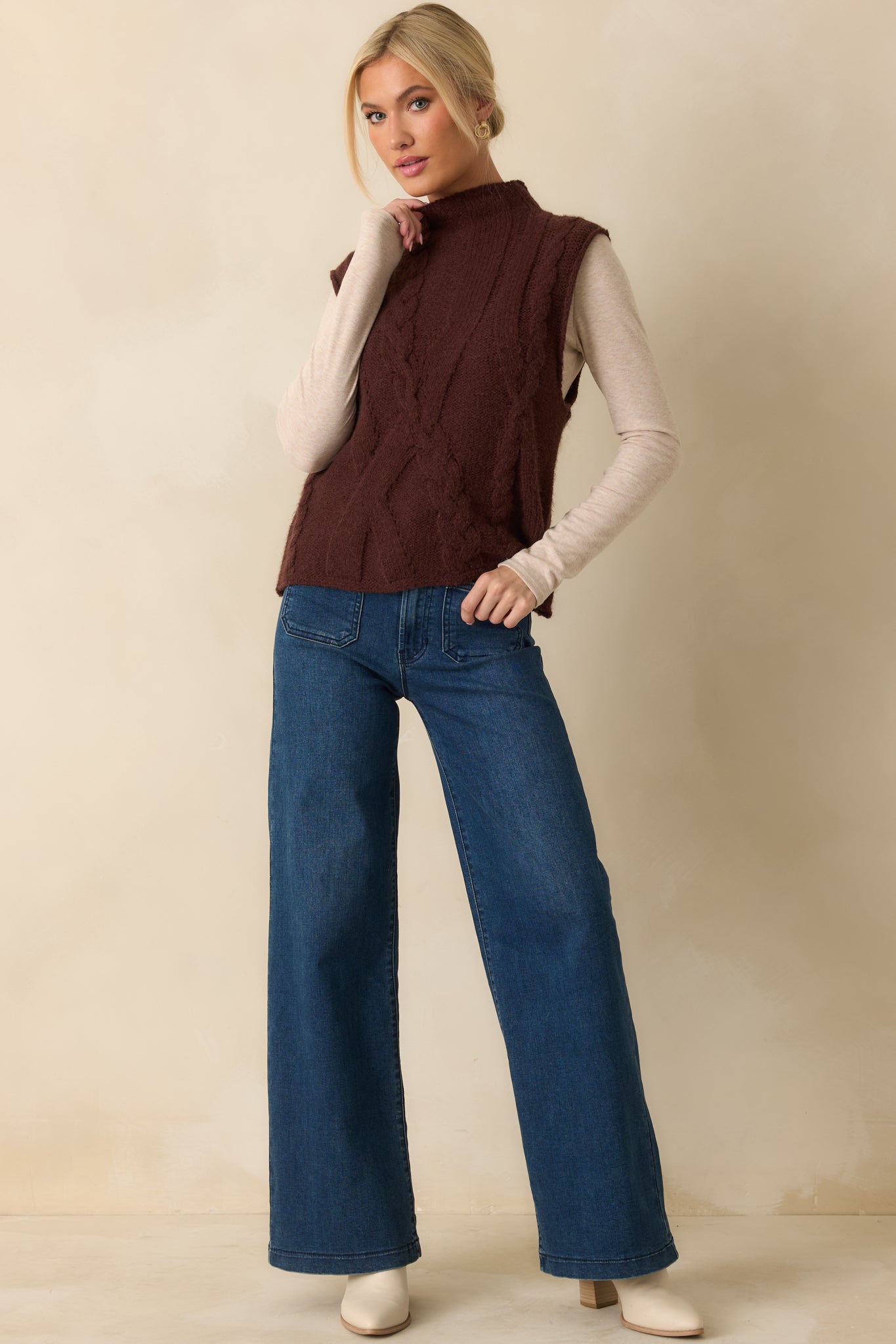 Cable knit brown sweater vest showcasing a soft, textured design and casual, comfortable shape.