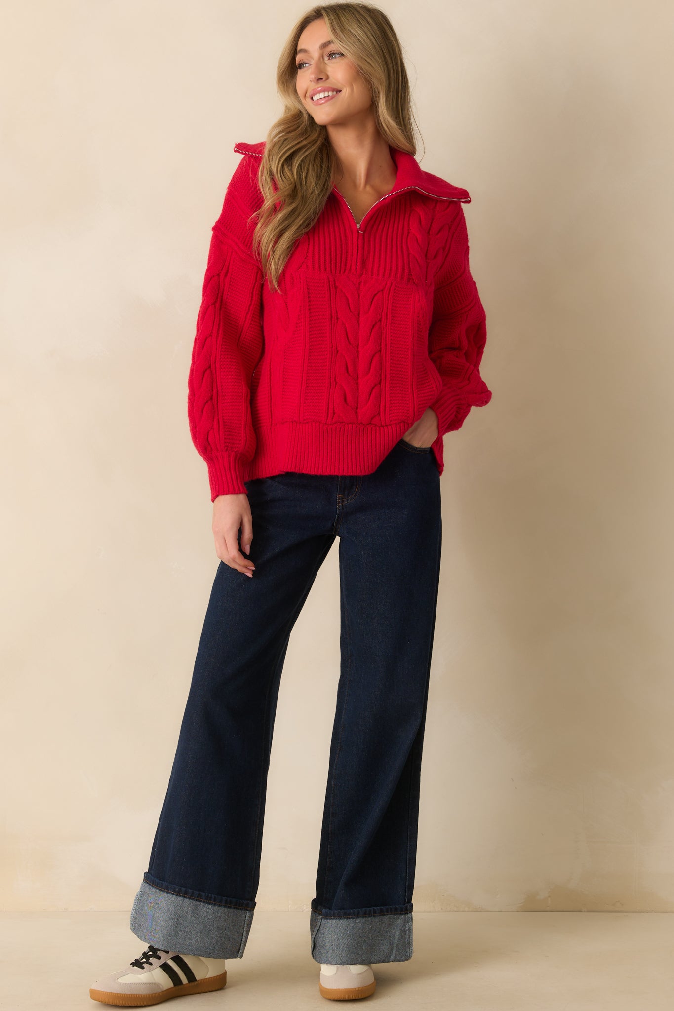 Cable knit sweater with quarter zip collar and casual, loose silhouette.