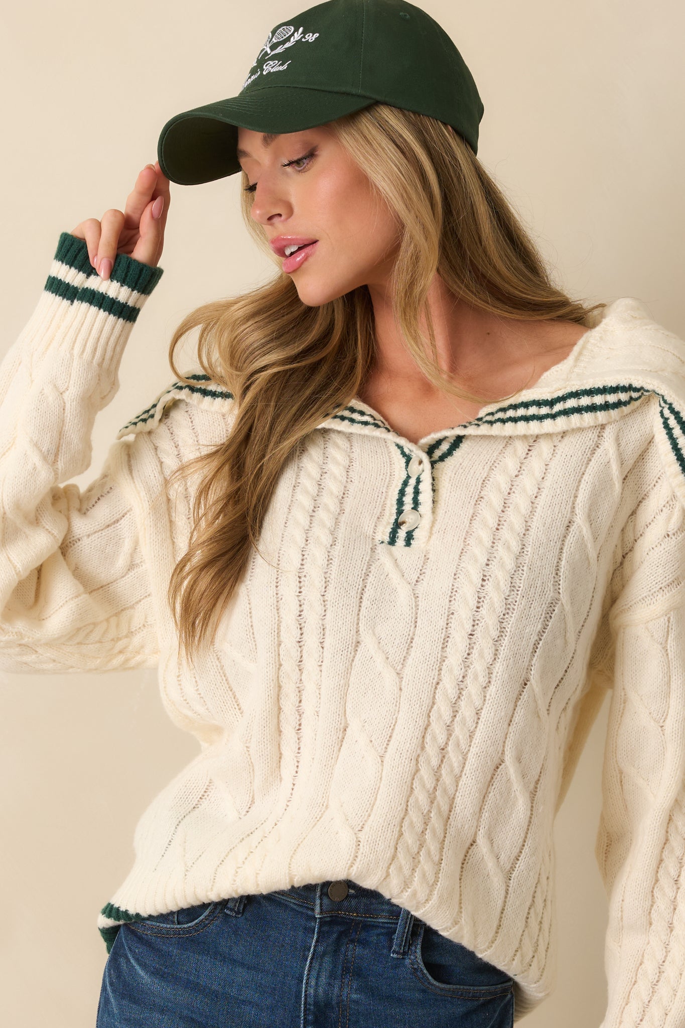 Up-close look at the cable knit texture and subtle hunter green stripes along the front.