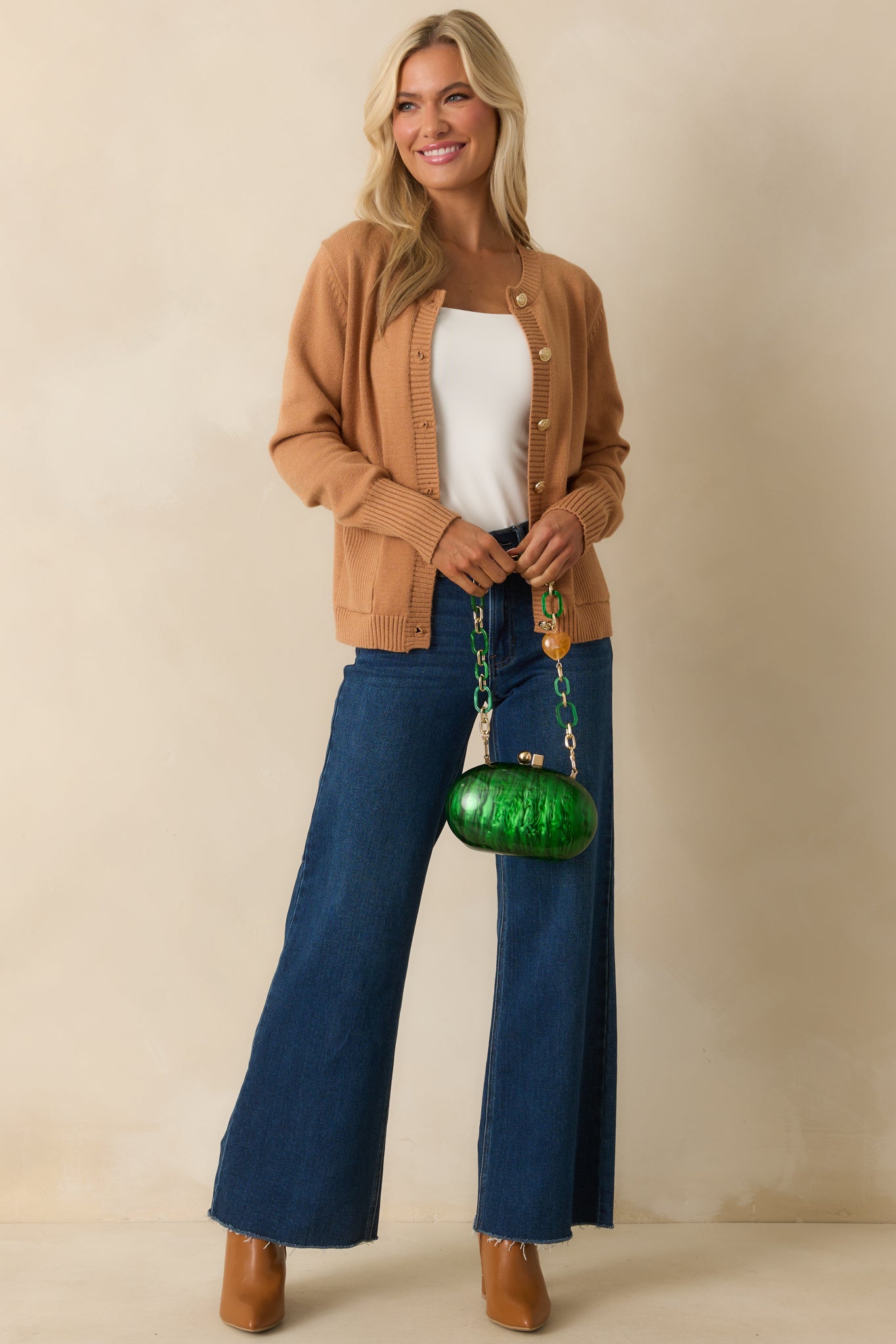 A full view of the camel brown cardigan with a crew neckline and relaxed fit.