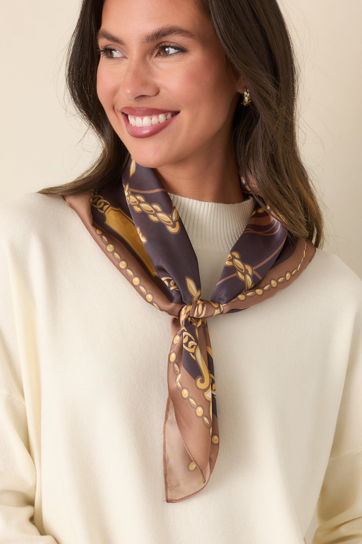  Camel and charcoal grey scarf featuring ornate gold chain motifs and decorative medallion details.