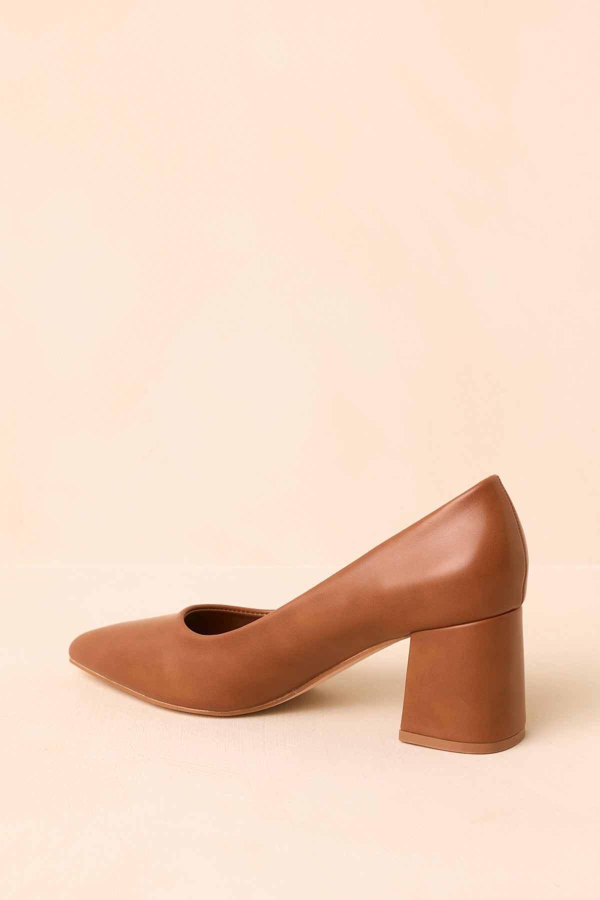 Camel closed-toe heels displaying the classic slip-on design and covered block heels.