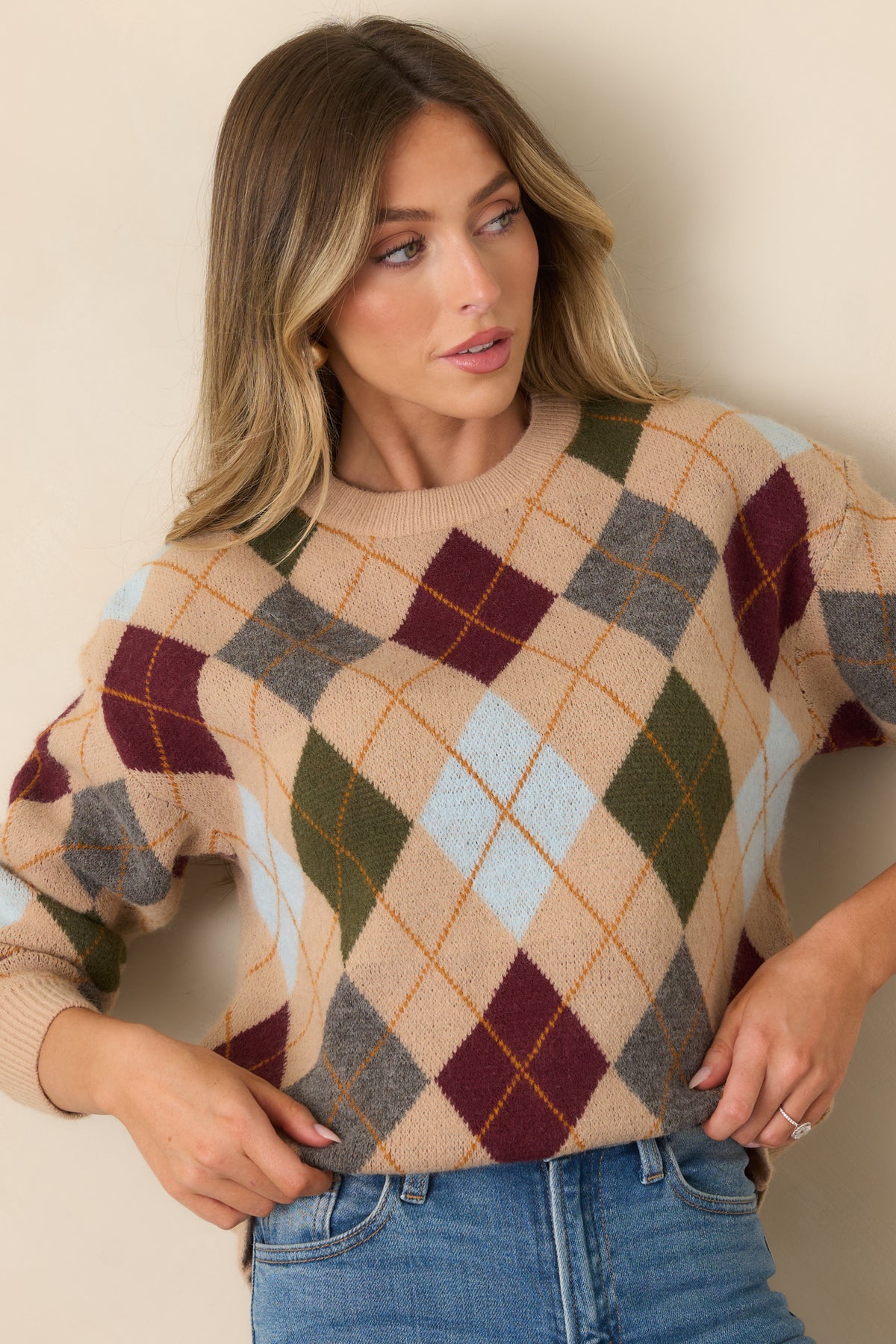 A classic crew neckline sits above the colorful diamond pattern of this relaxed knit top.