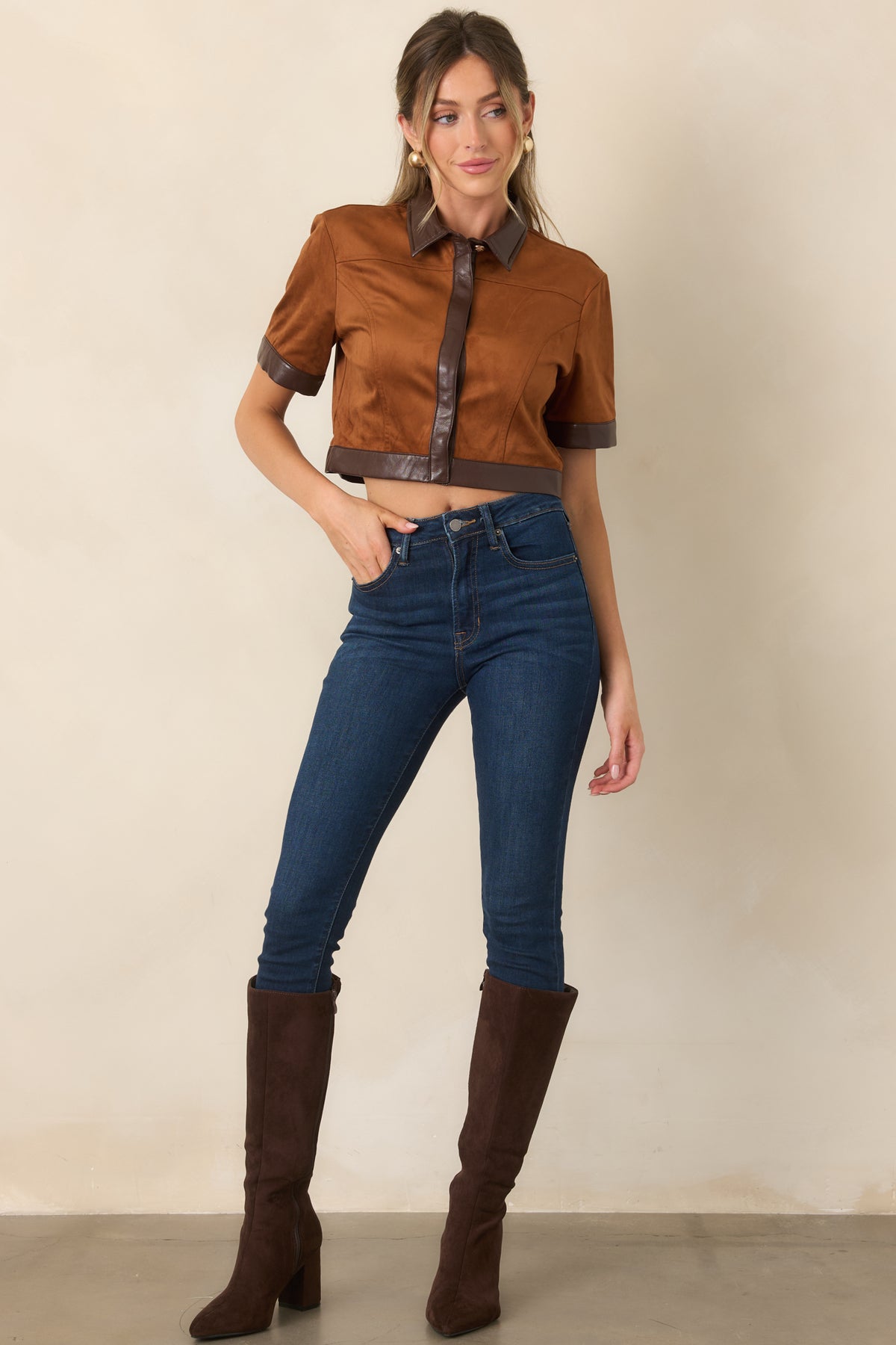 Warm camel faux suede top with chocolate brown faux leather trim, pointed collar, and cropped hem.