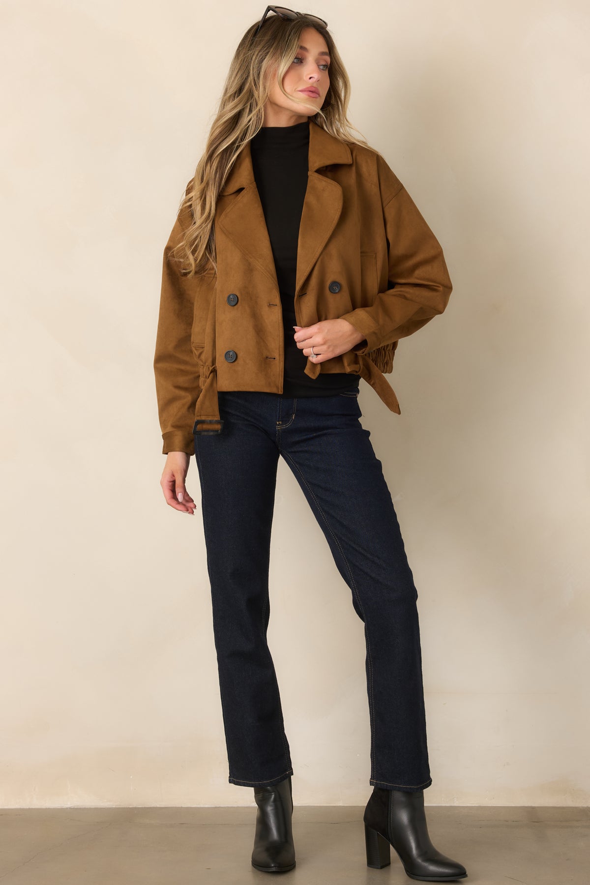 Camel faux suede trench coat featuring a belted waist and cropped silhouette.


