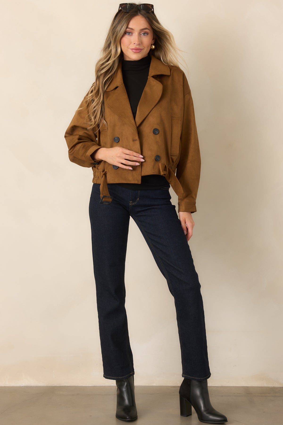  Camel faux suede cropped trench coat with a double-breasted button front and wide lapel collar.