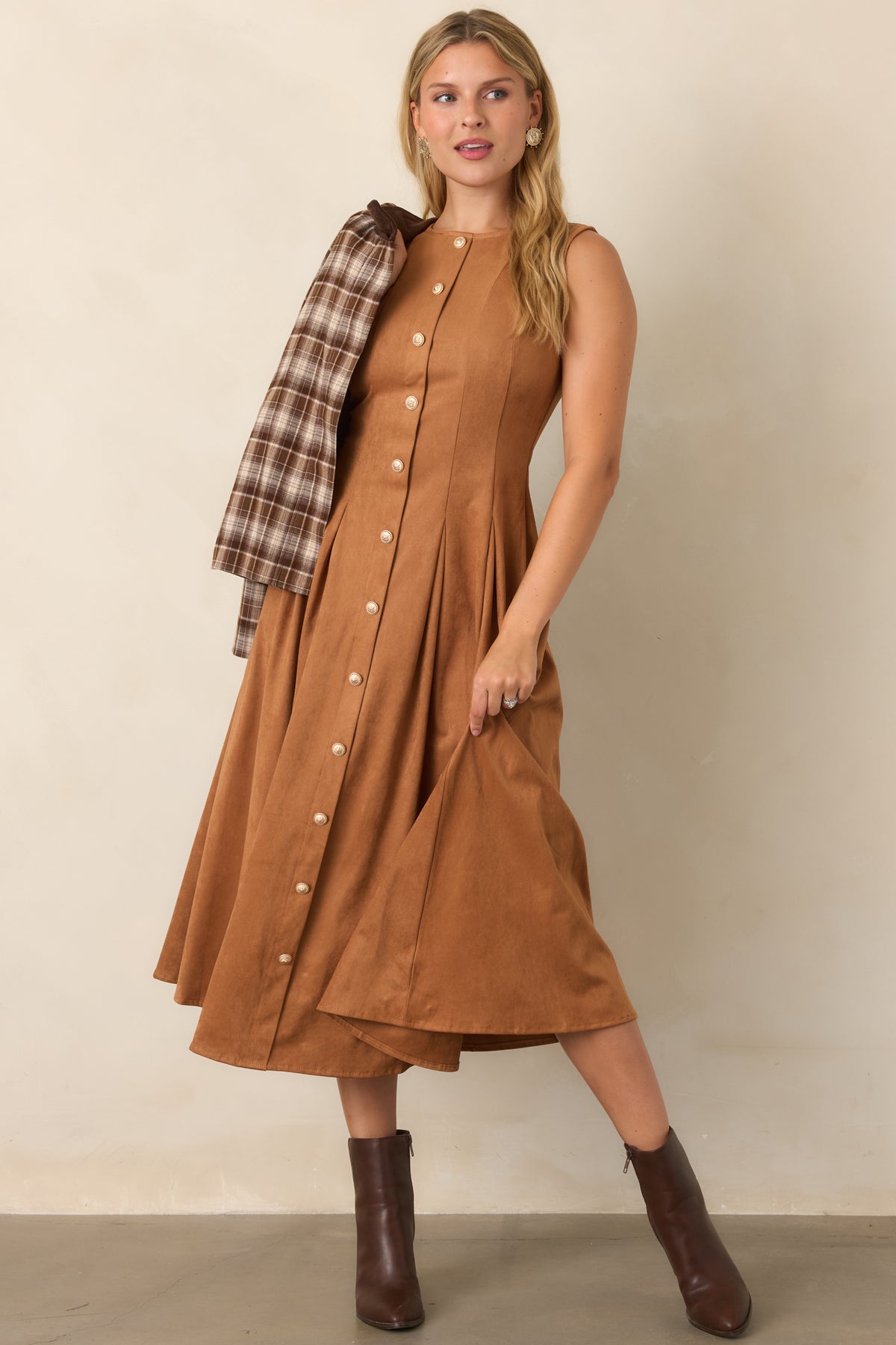 Camel faux suede midi dress featuring a sleeveless silhouette, round neckline, tailored princess seams, fitted bodice, and pleated skirt with ornate gold-tone buttons.