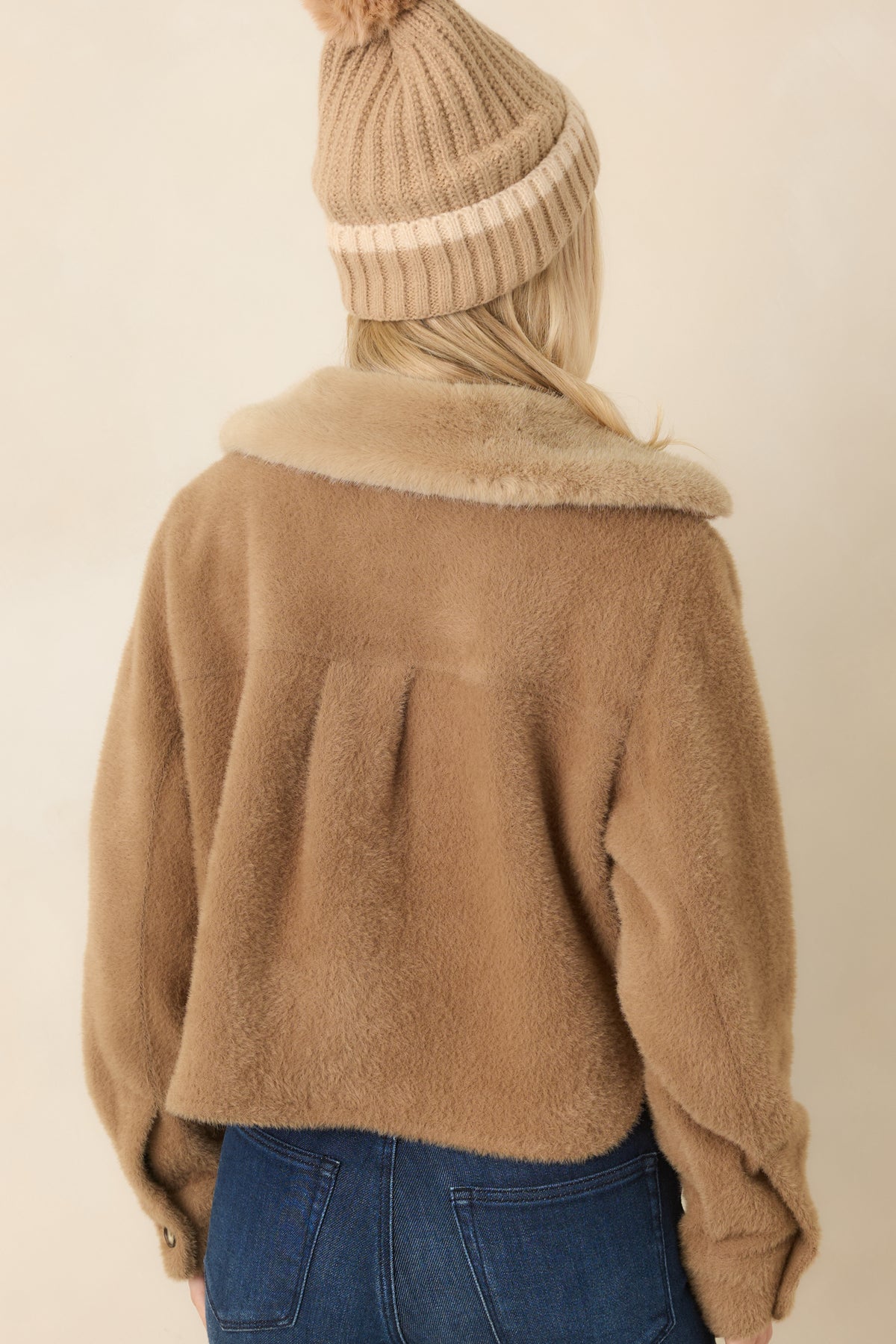 Camel jacket with a back yoke, center pleat, relaxed boxy fit, and softly brushed fabric.