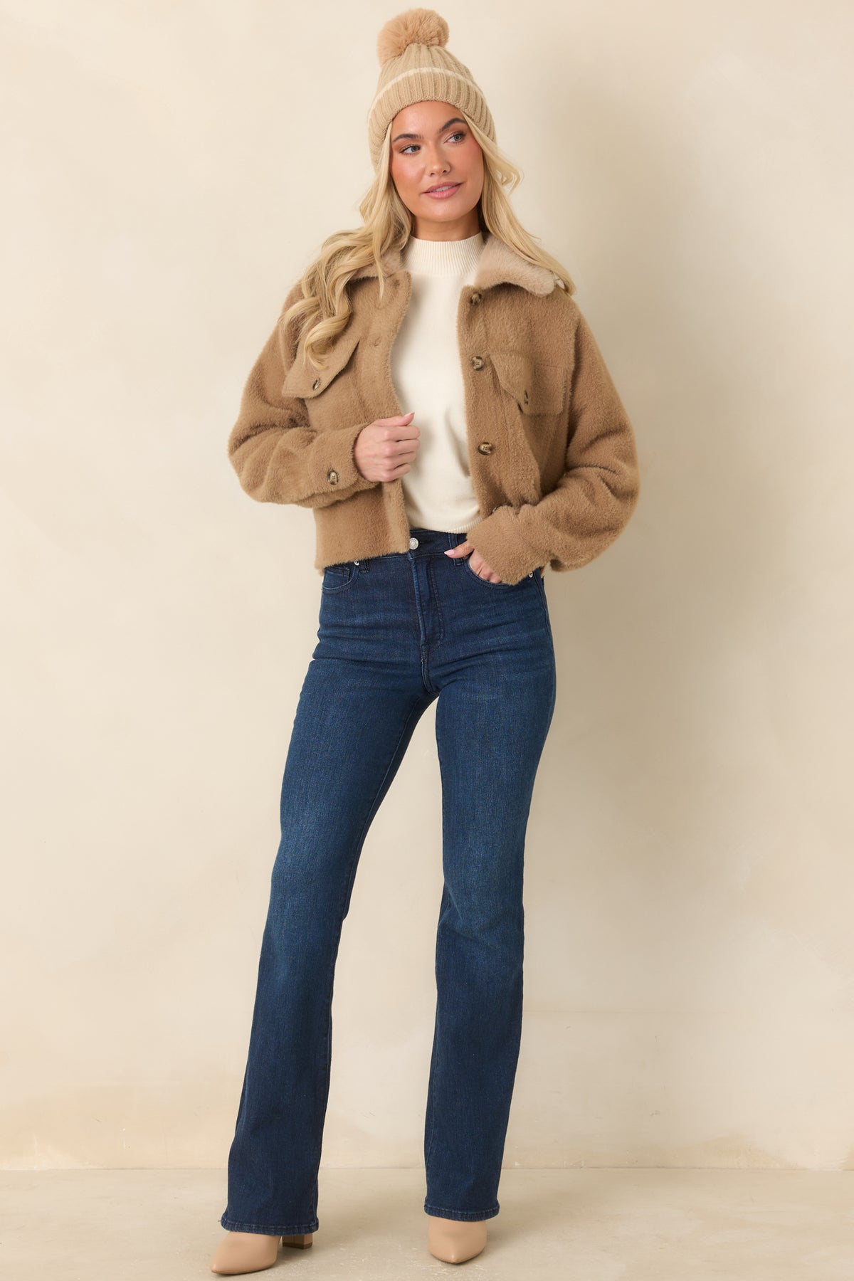 Camel jacket with a tonal faux fur collar, button front, and two buttoned flap chest pockets.