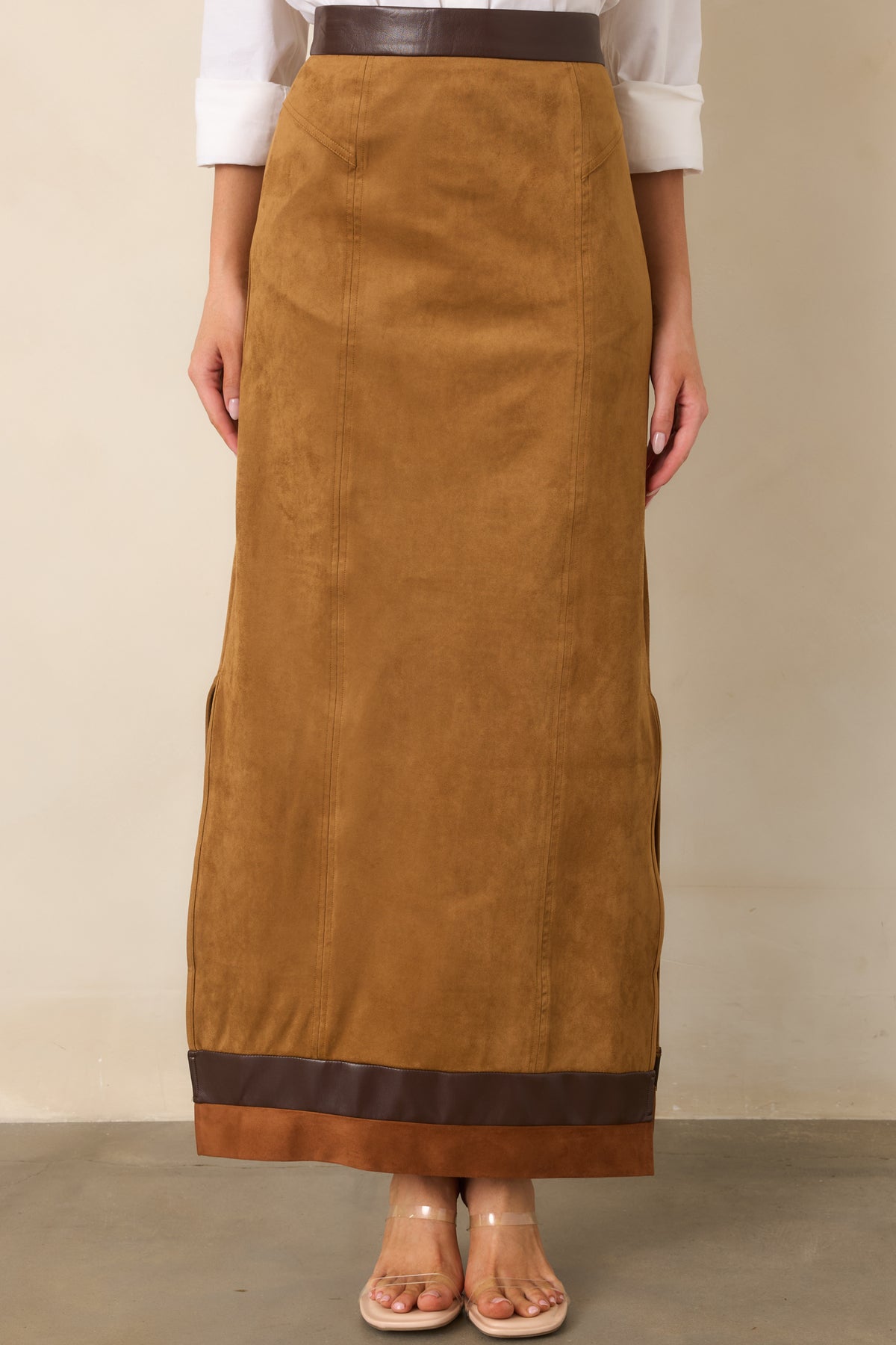 Camel maxi skirt showcasing the contrast trim near the hem and subtle side slit.