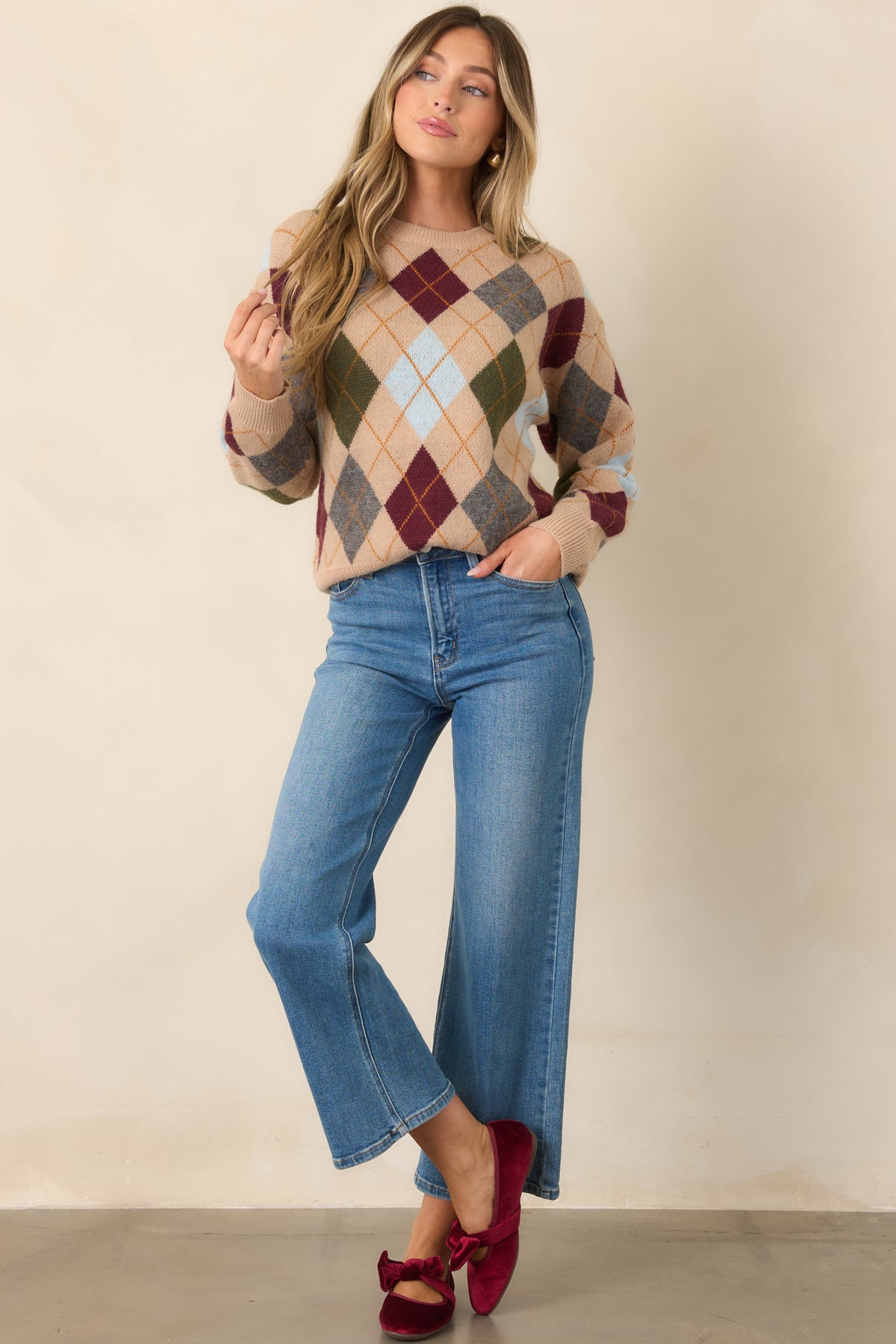Camel knit top with a multicolor diamond pattern, crew neckline, long sleeves, and ribbed trim.