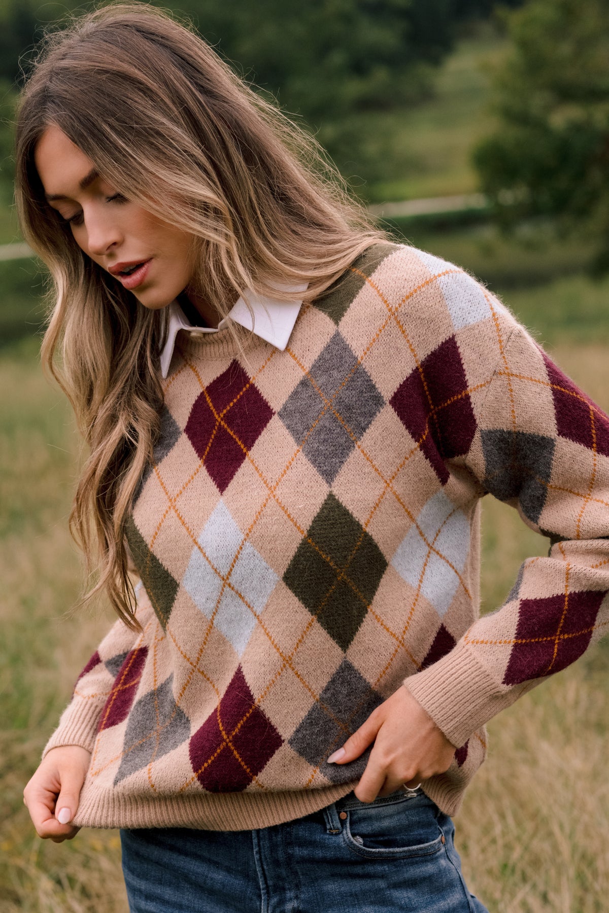 The camel knit fabric features an intricate diamond pattern accented with burgundy, olive, grey, blue, and golden tones.