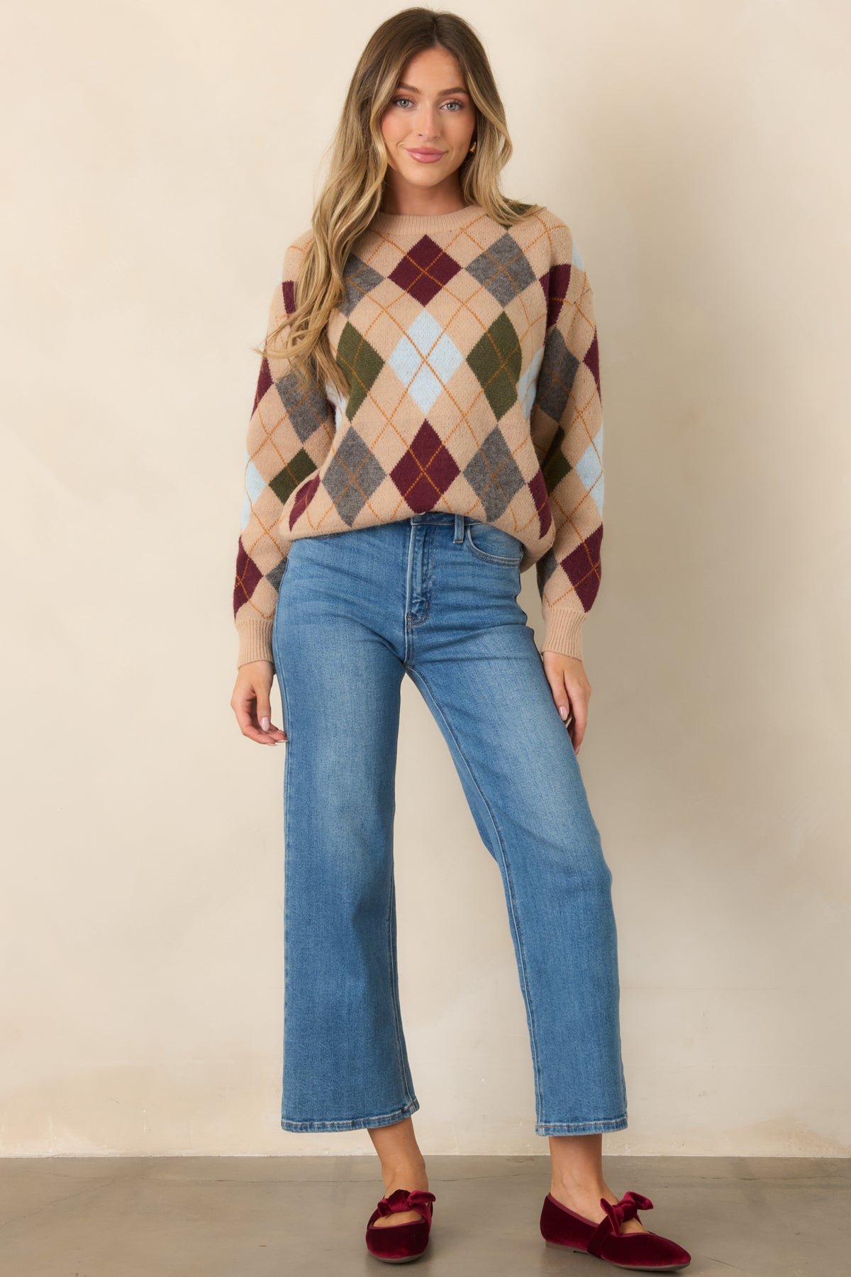 A relaxed fit and dropped shoulders complement the colorful geometric pattern of this camel knit top.
