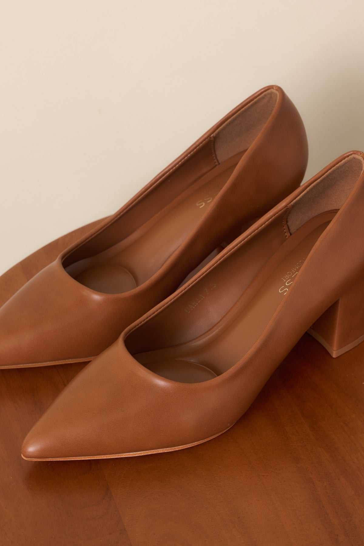 Camel slip-on heels featuring a streamlined silhouette and closed pointed toes.