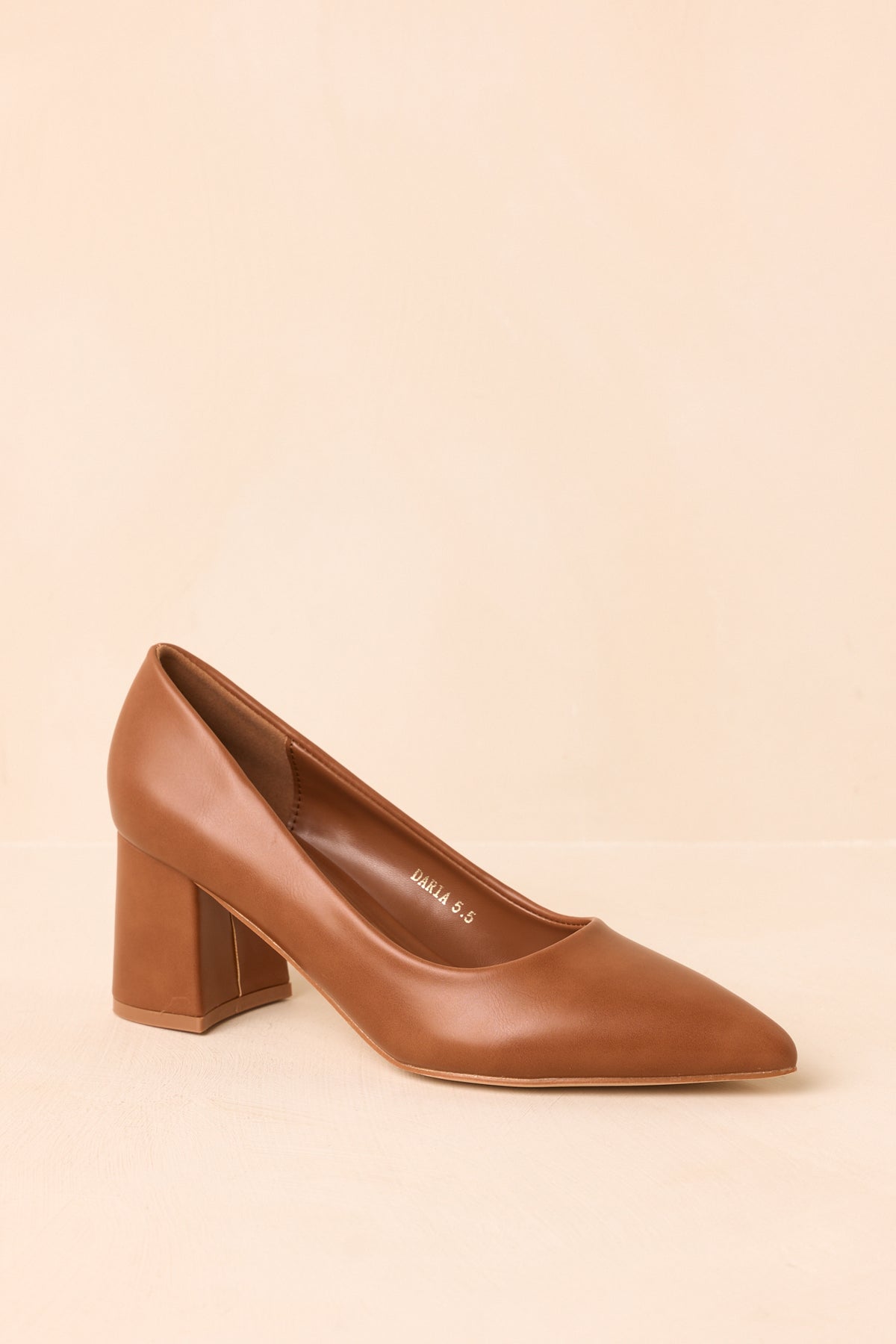 Warm camel slip-on heels displaying the pointed toe and smooth streamlined shape.
