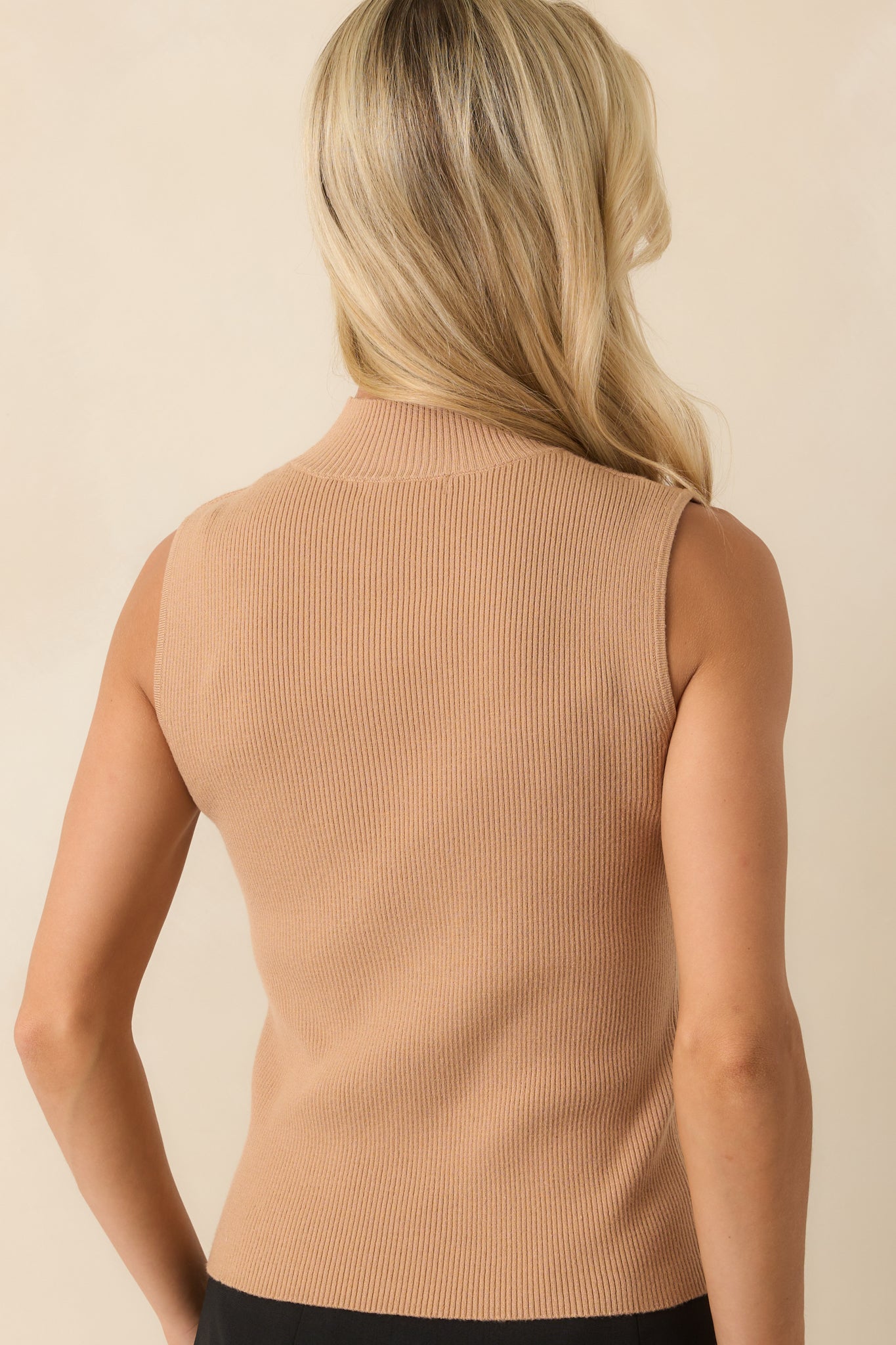 A back view of the camel top displaying the fitted shape and sleeveless cut from behind.