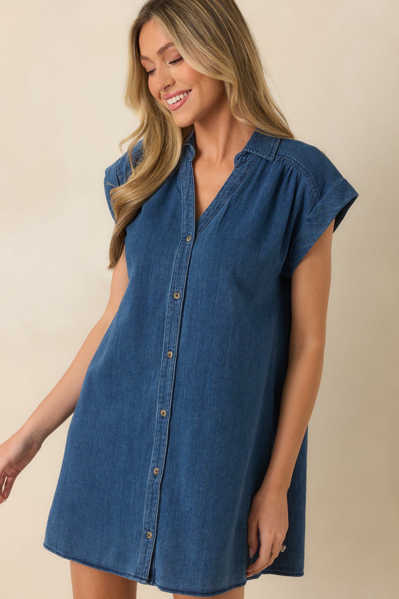 Detailed view of the camp collar, tonal button-front closure, and soft indigo twill fabric.