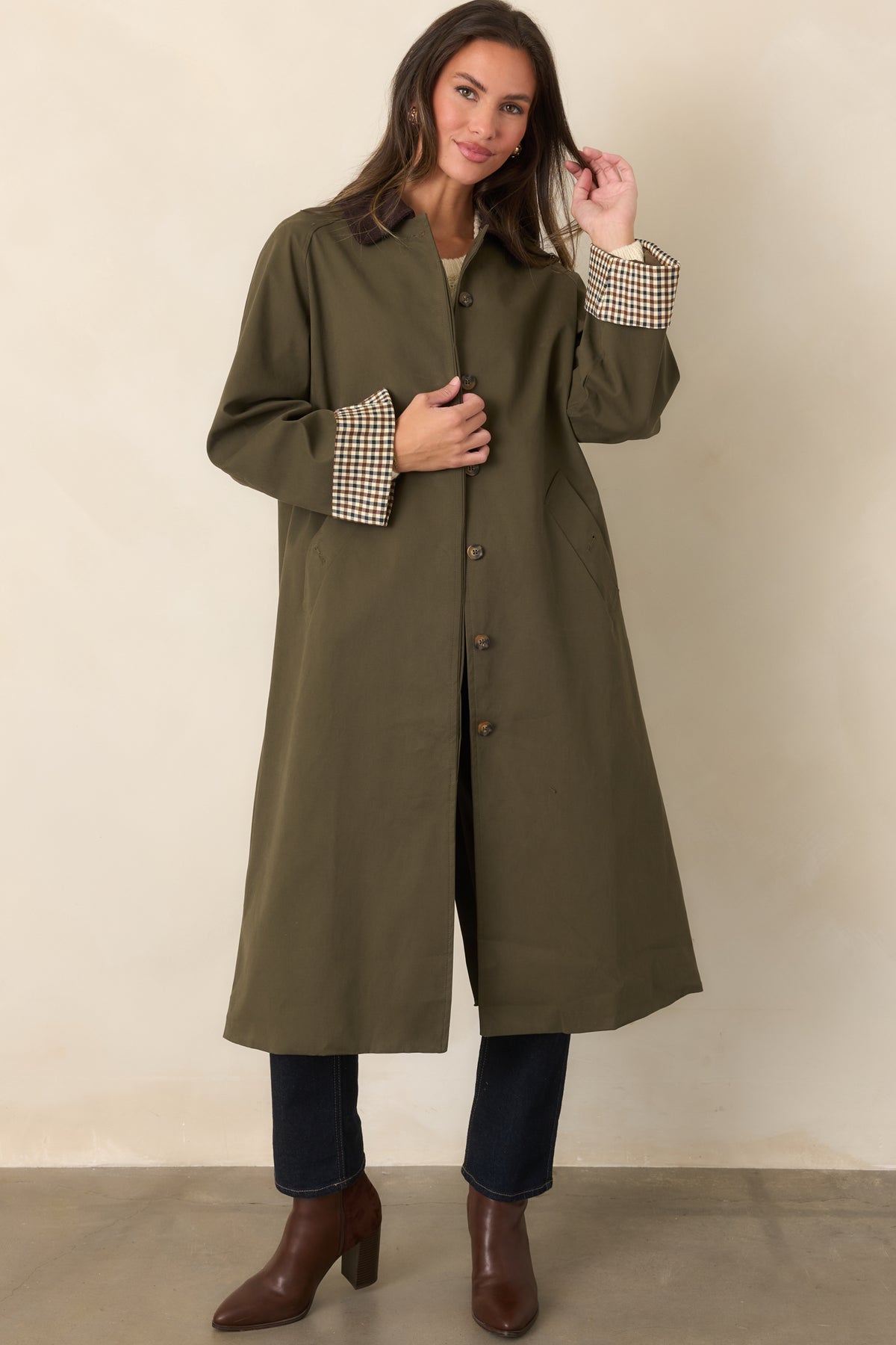 Canvas-feel coat featuring a defined waist, button front, checked cuffs, and chocolate brown collar.
